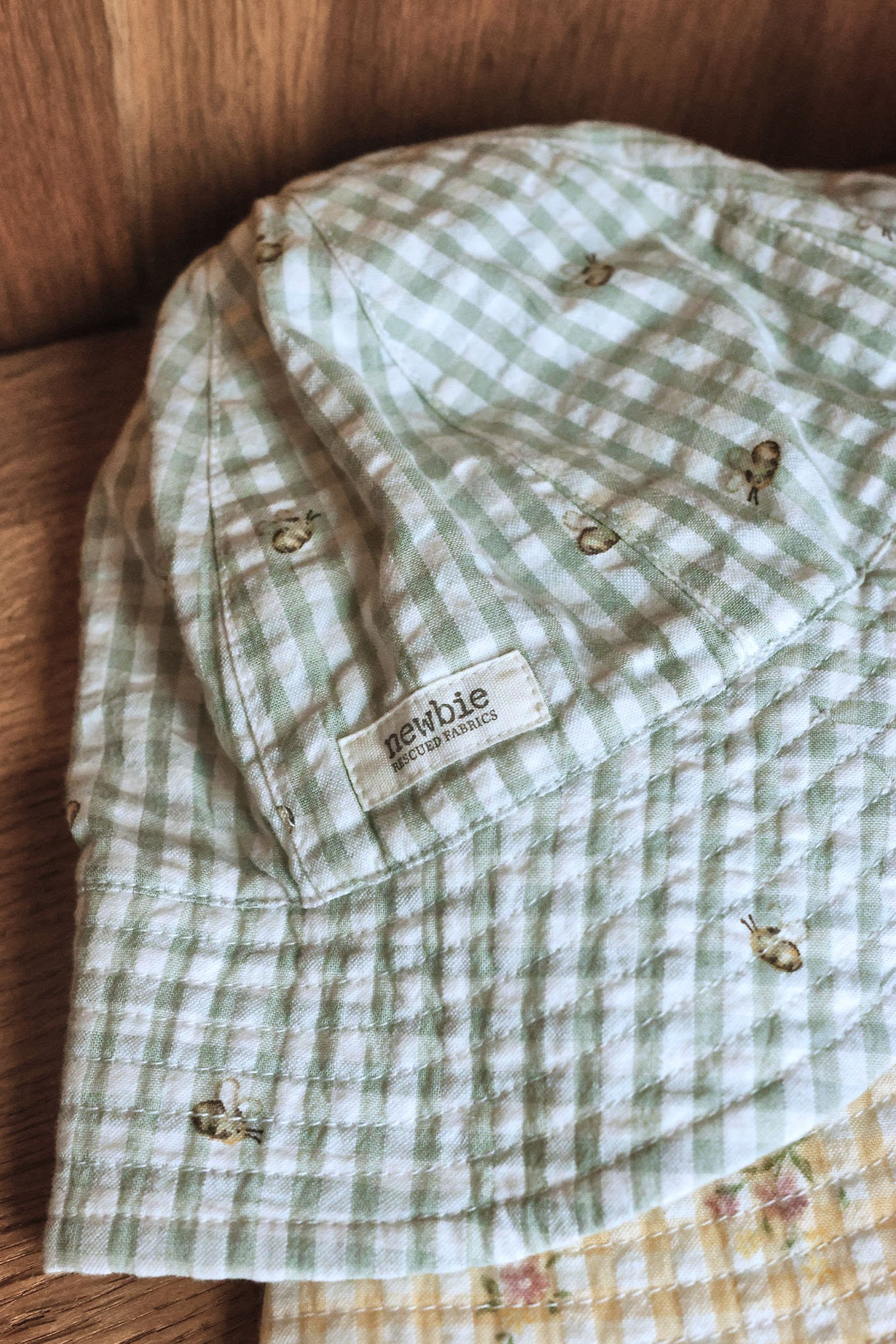 Green gingham bucket hat with bee pattern