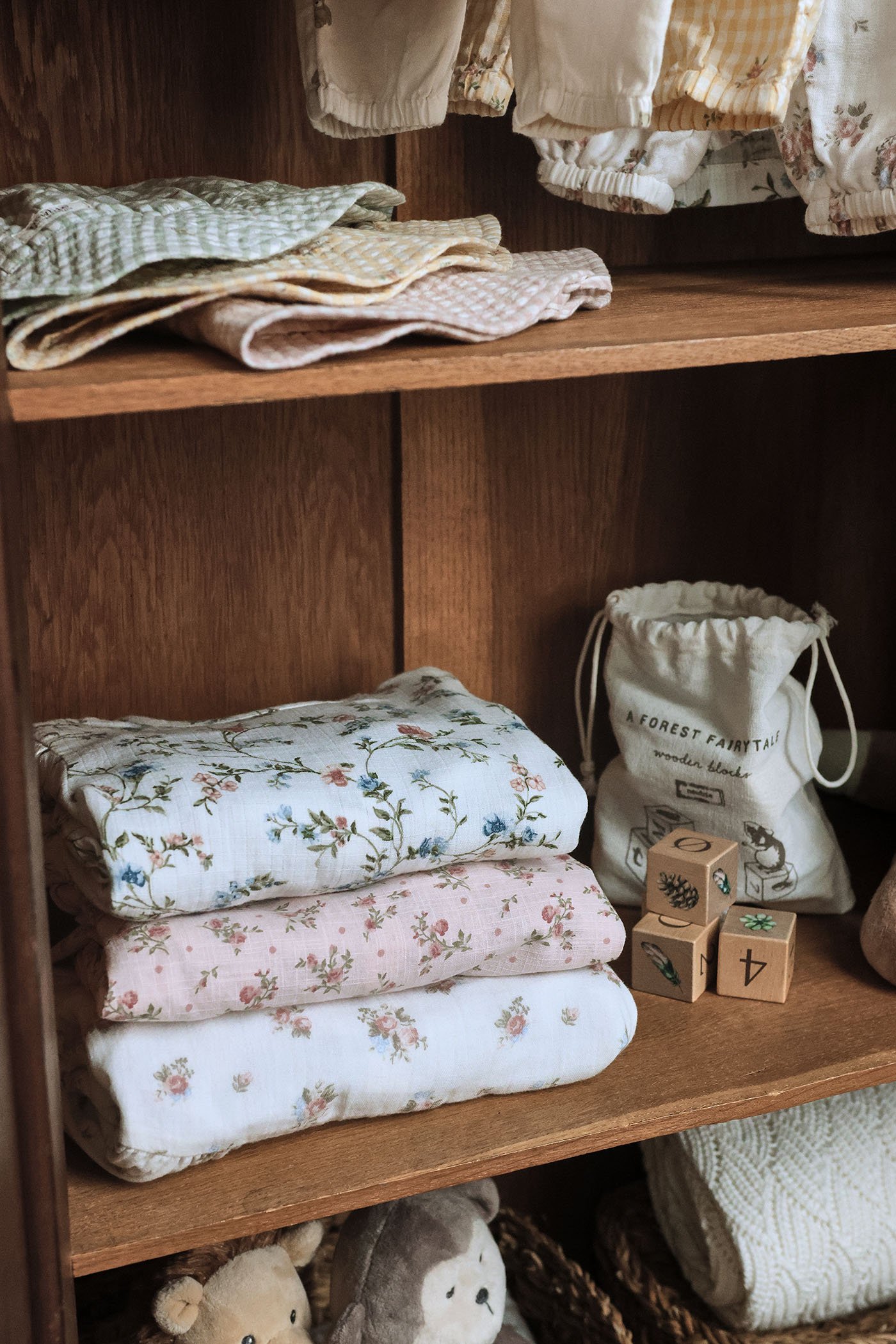 Floral dresses, stacked in a kids’ wardrobe