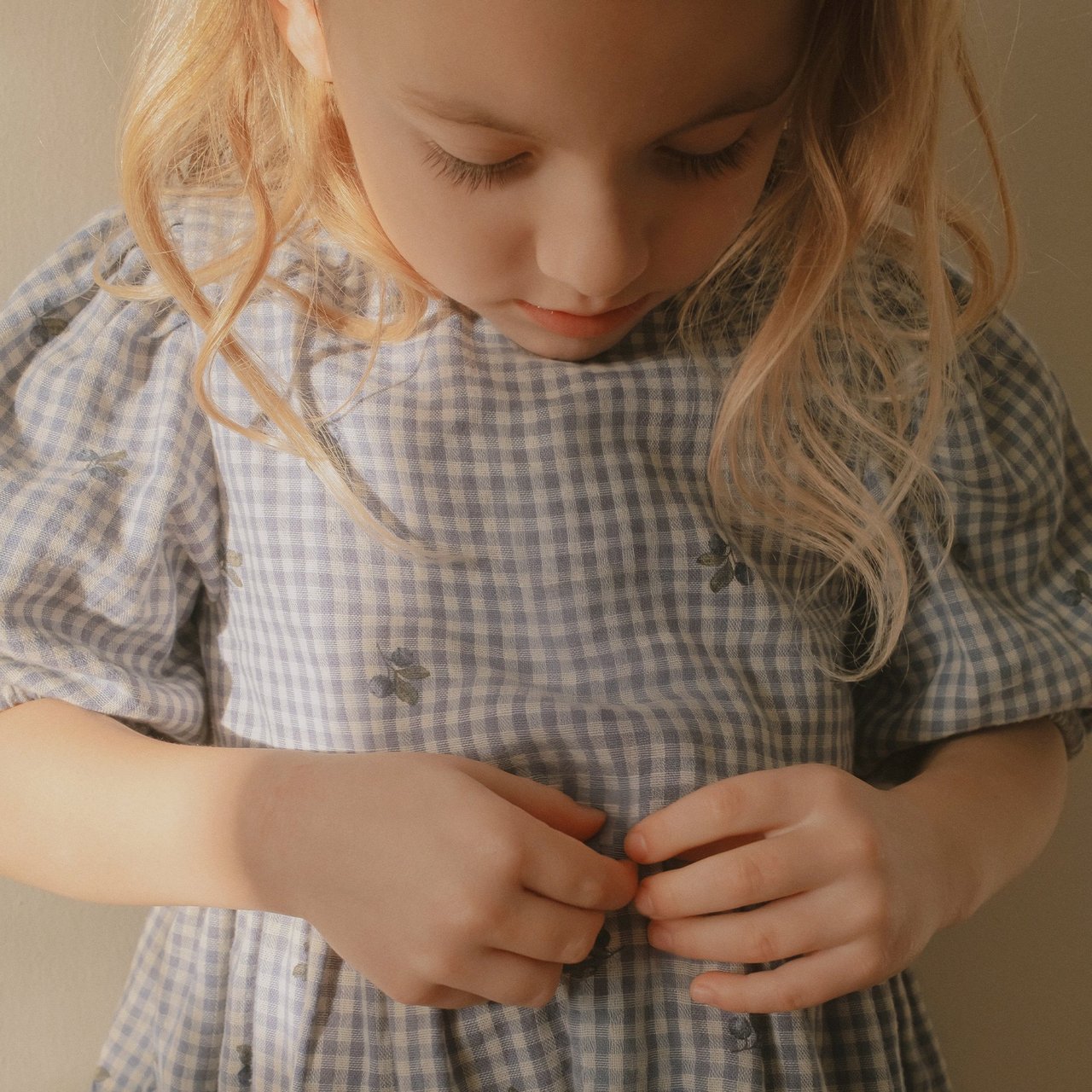 Girl wearing a checked blueberry patterned dress