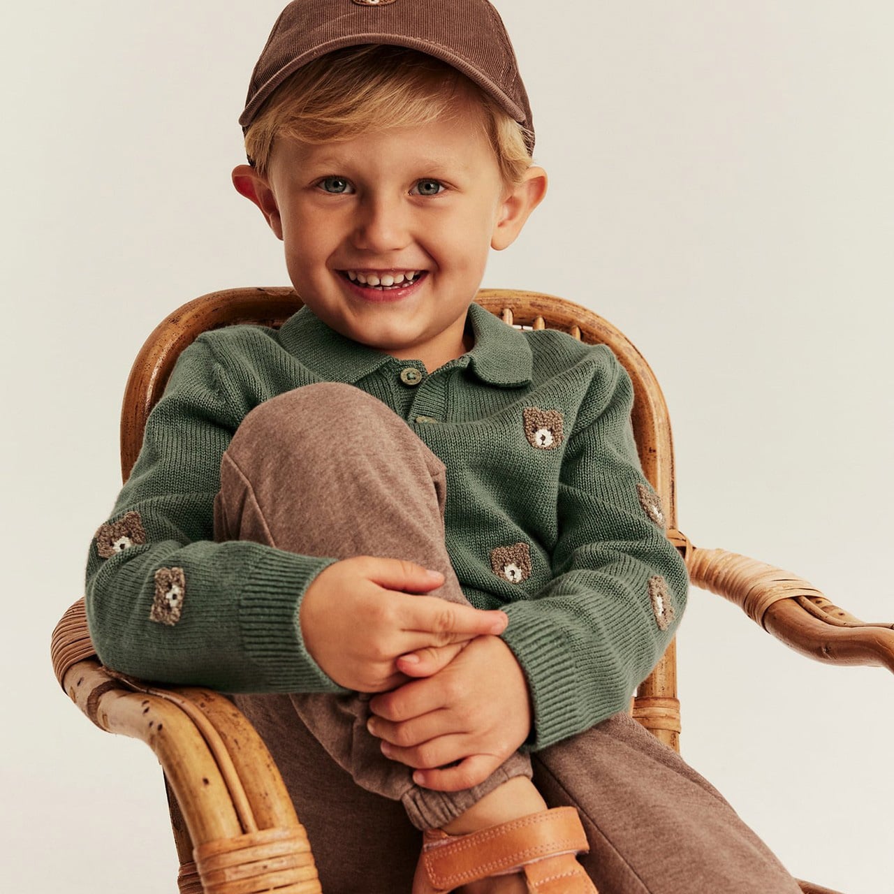 Light beige short‑sleeved T-shirt on child, with henley button placket, chest pocket and soft cotton texture.