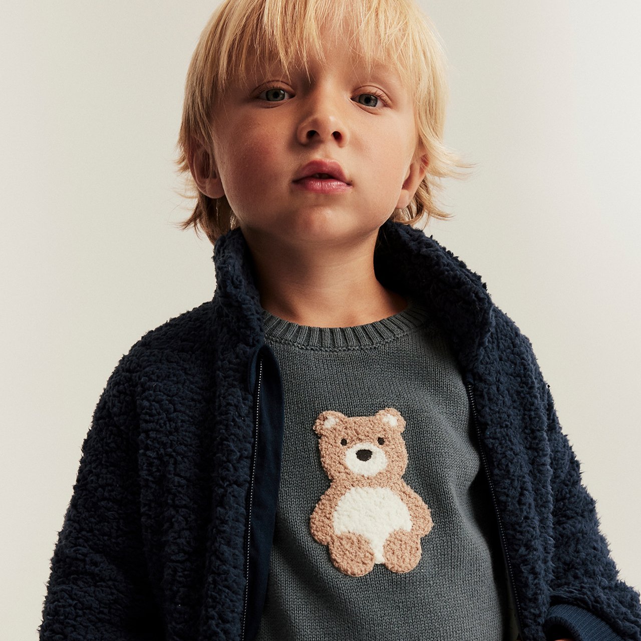 Boy wearing a shirt with a teddybear on it