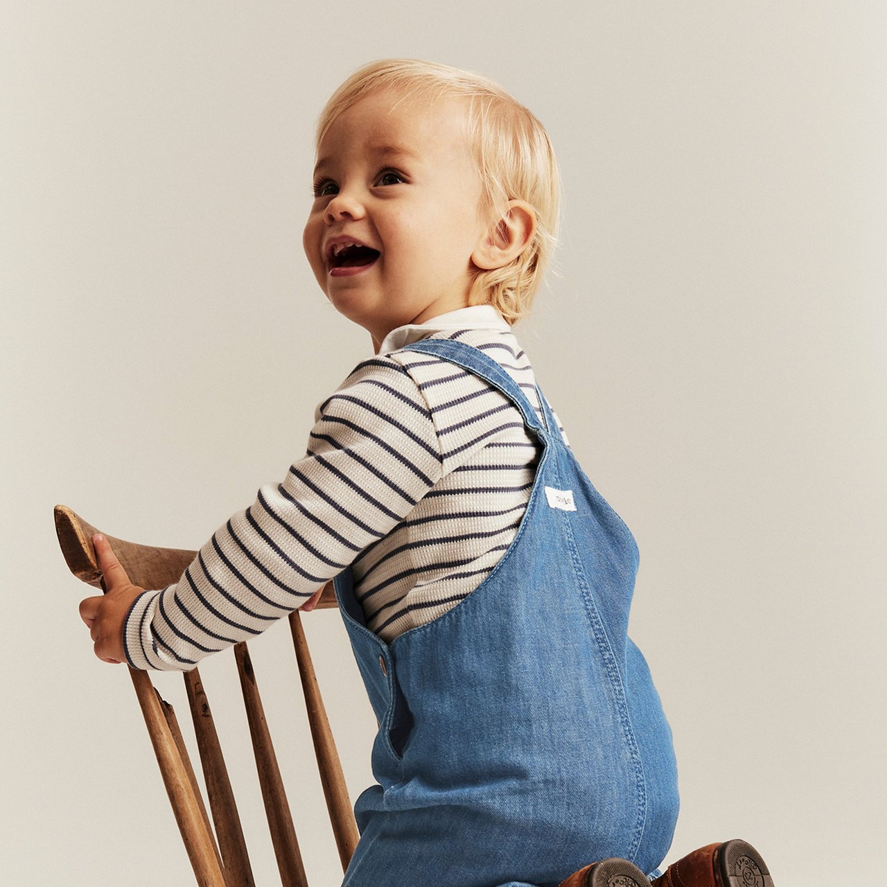 Baby boy in blue dungarees
