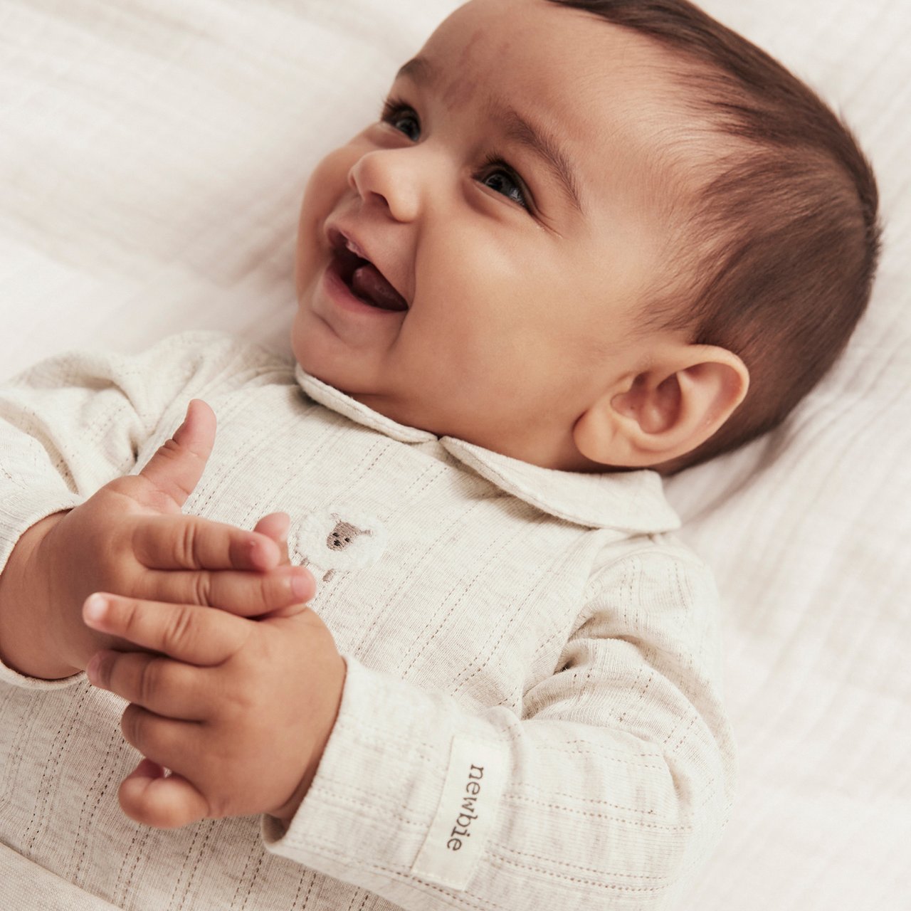 Baby in beige bodysuit