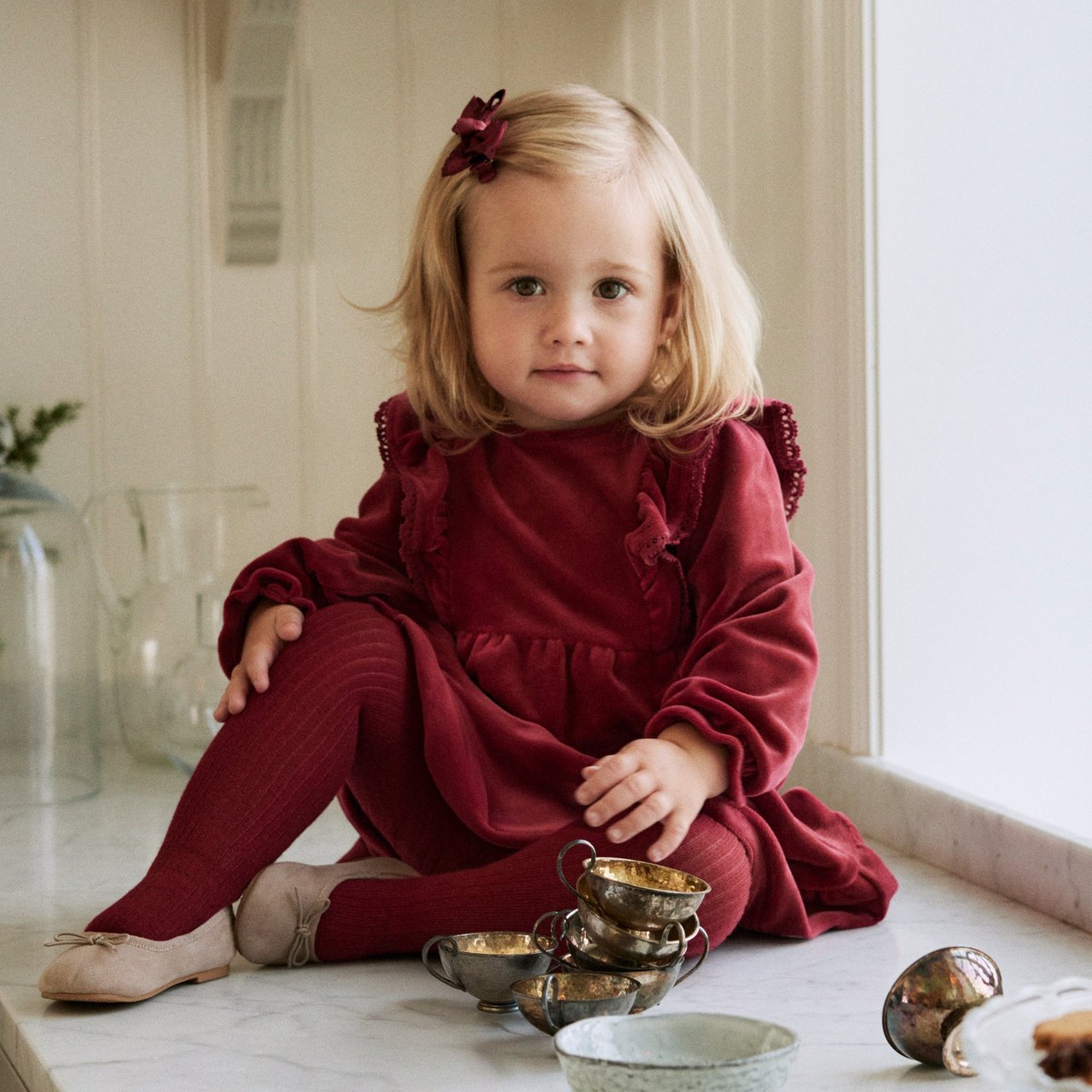 Baby girl wearing a red velour dress