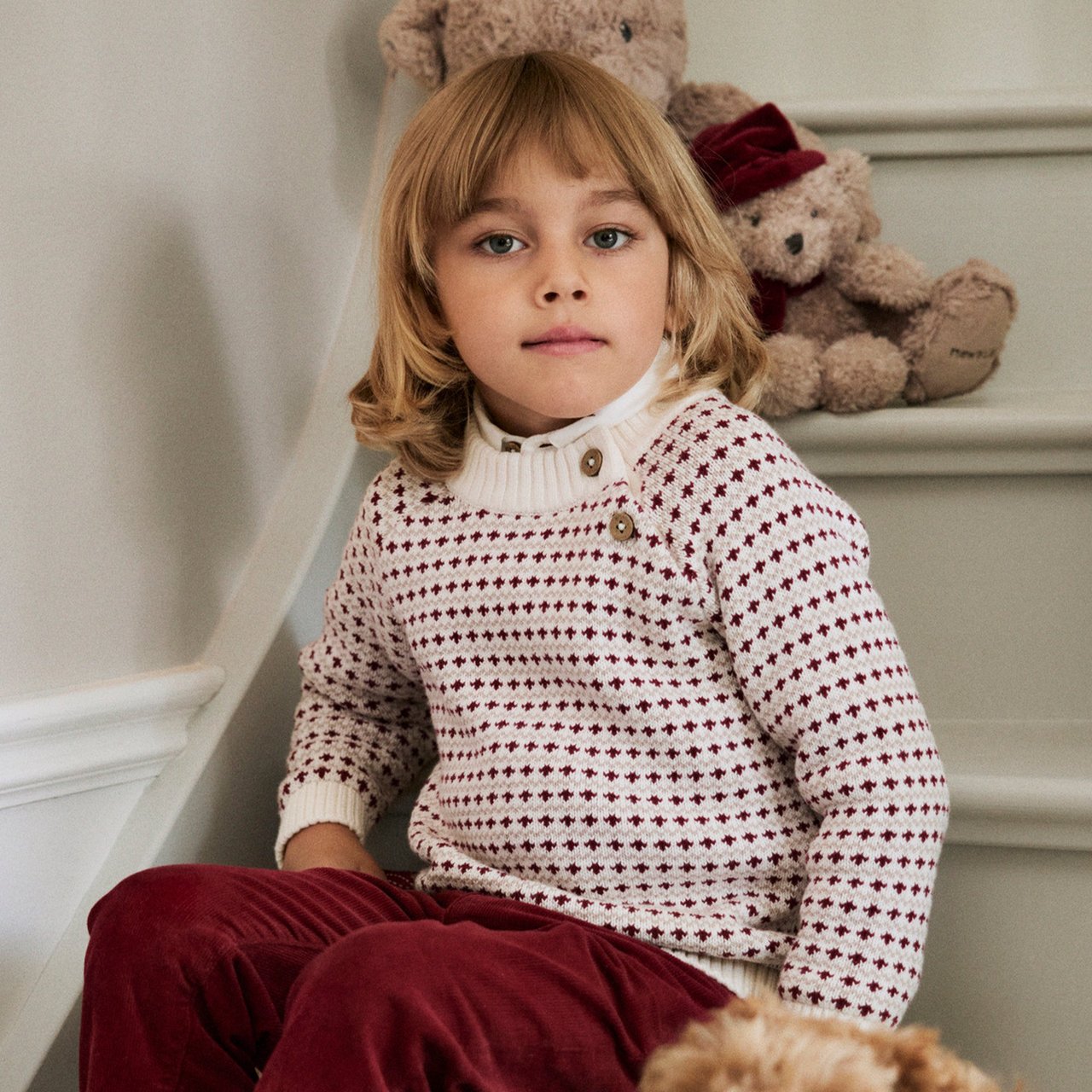 Boy wearing a red(white knitted christmas sweater