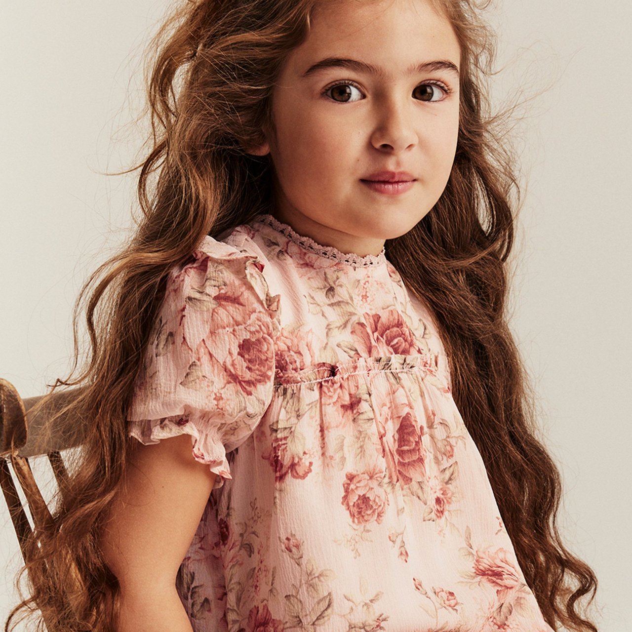 Girl wearing a floral dress with pink details