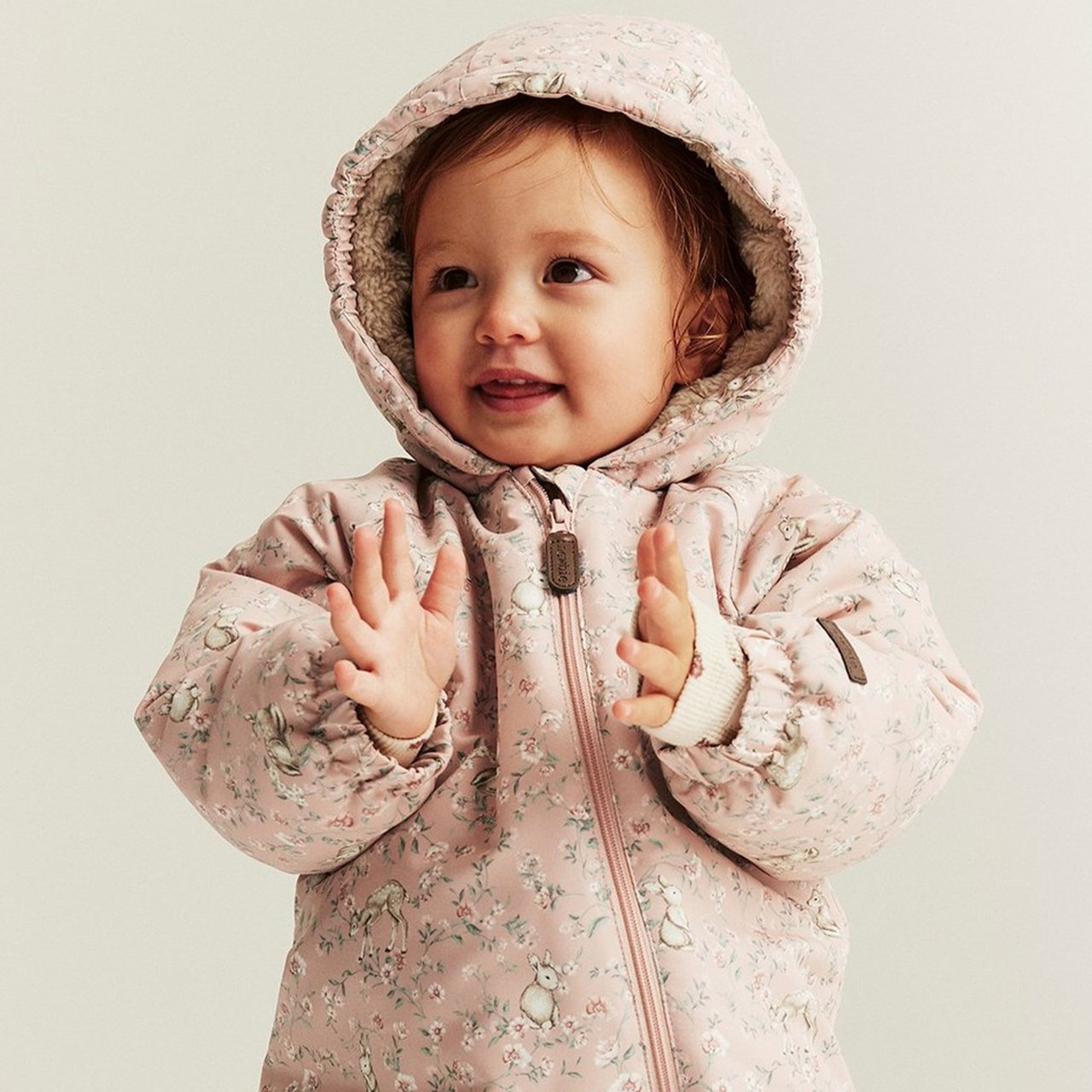 Kids wearing warm jackets in beige and pink