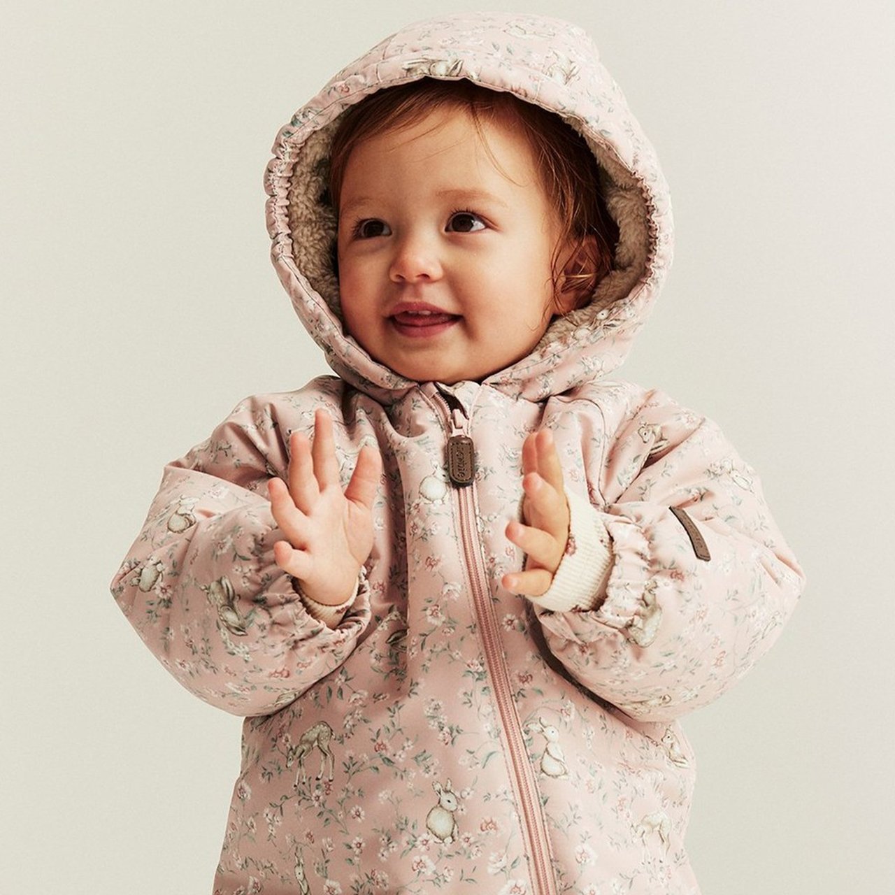 Kids wearing warm jackets in beige and pink