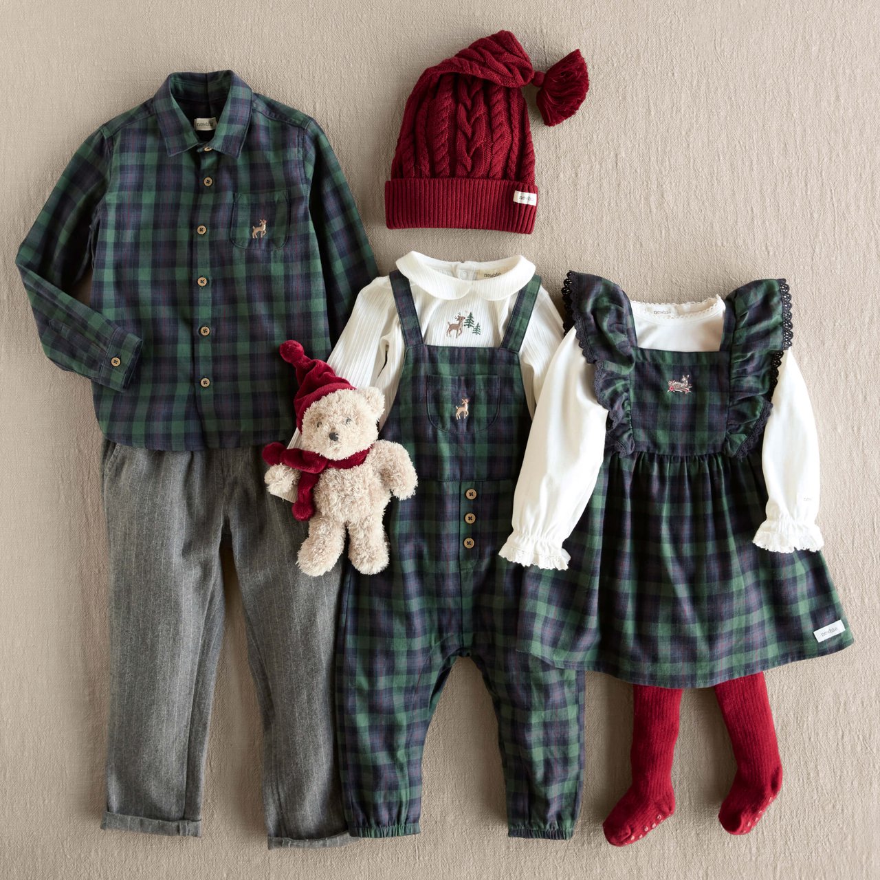 Two children wearing matching red velour dresses