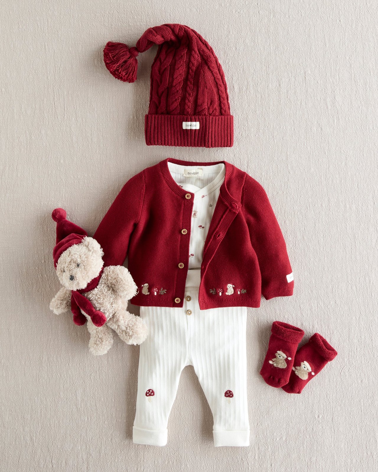Baby outfit with teddy bear and mushroom details.