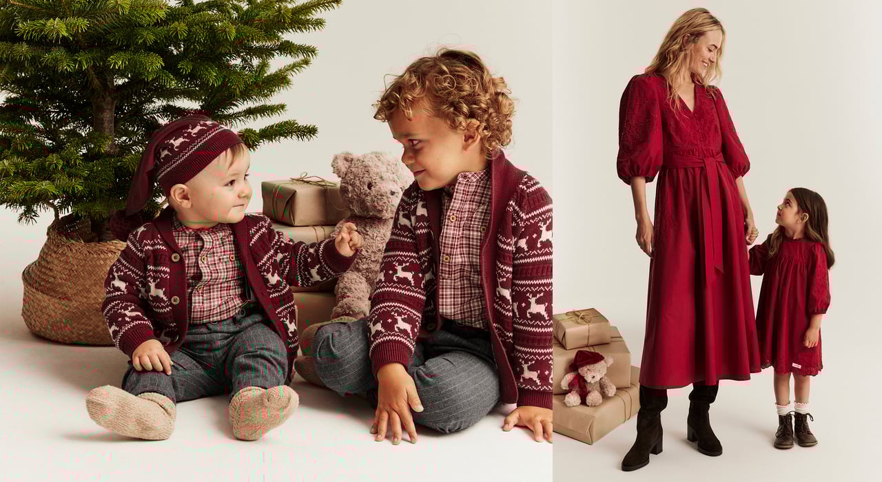 Kids and woman in matching festive outfits by the Christmas tree.