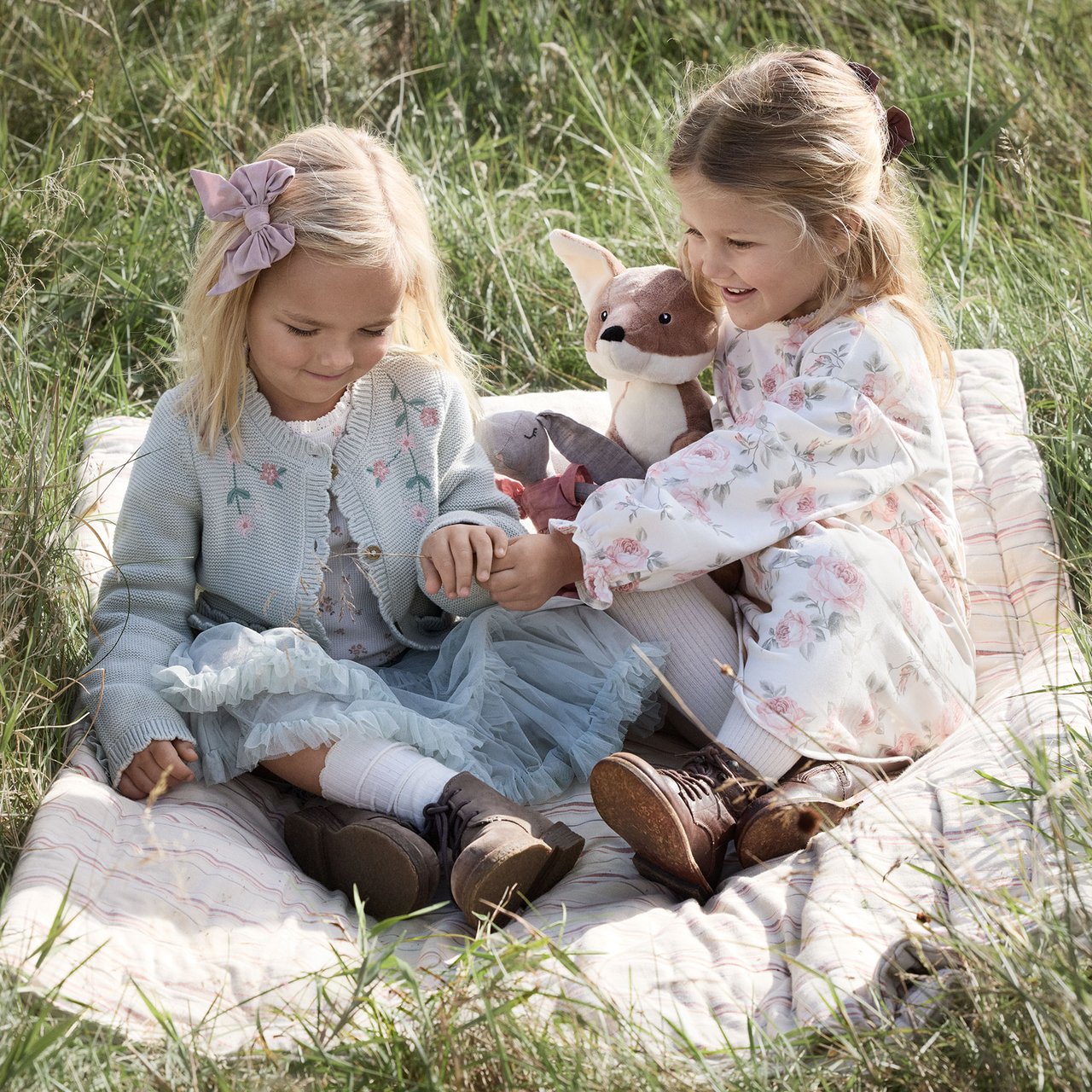 Girls on a blanket on the grass