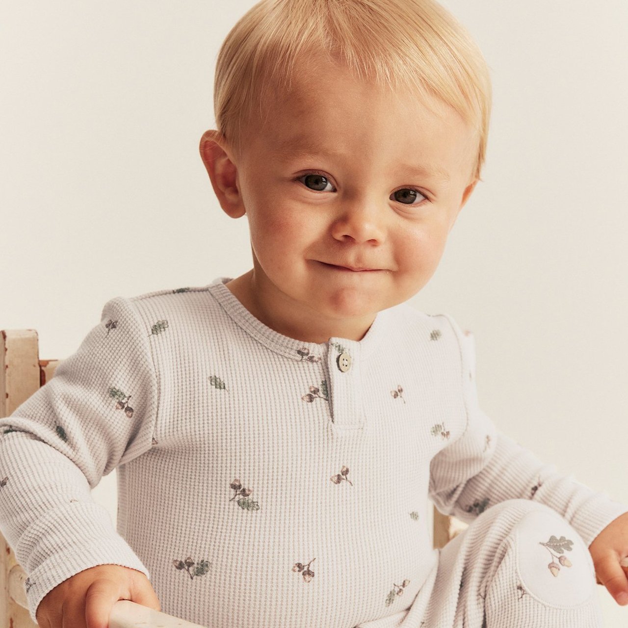 Boy in a beige bodysuit
