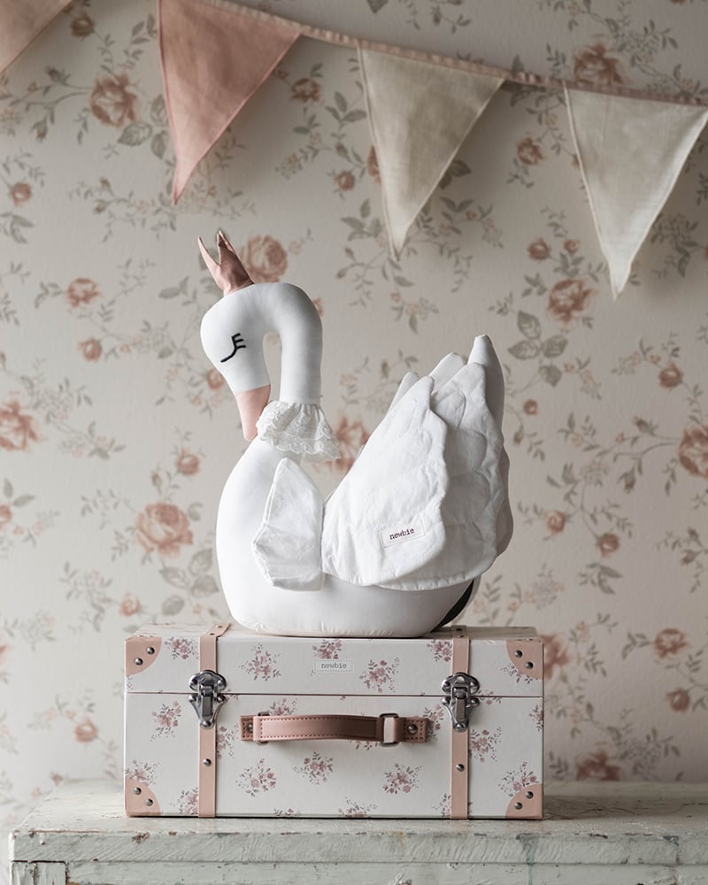 Koffer mit Blumenmuster und einem Spielzeug-Schwan