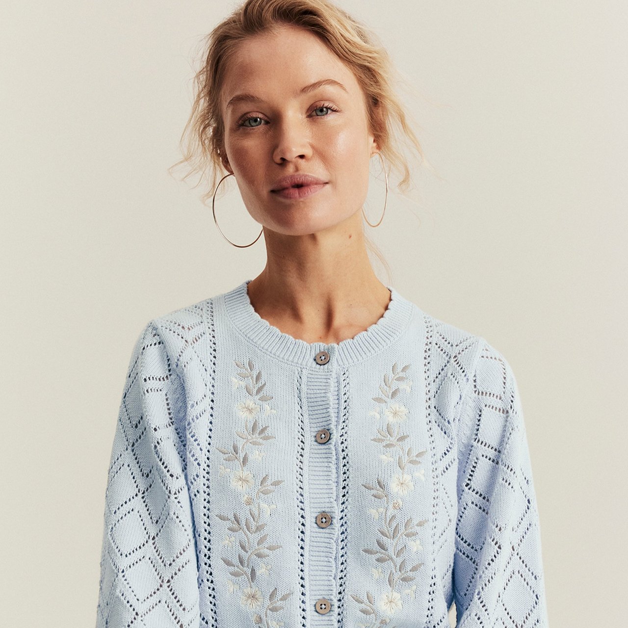 Woman wearing a blue, knitted cardigan