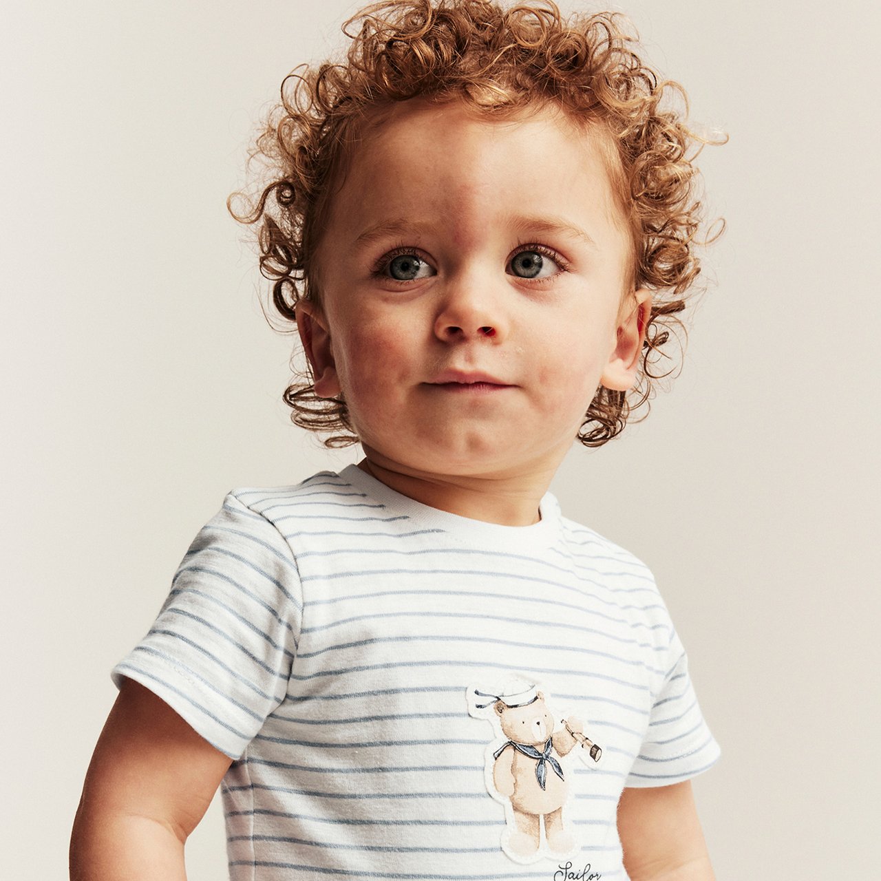 Little boy wearing a blue denim dungaree