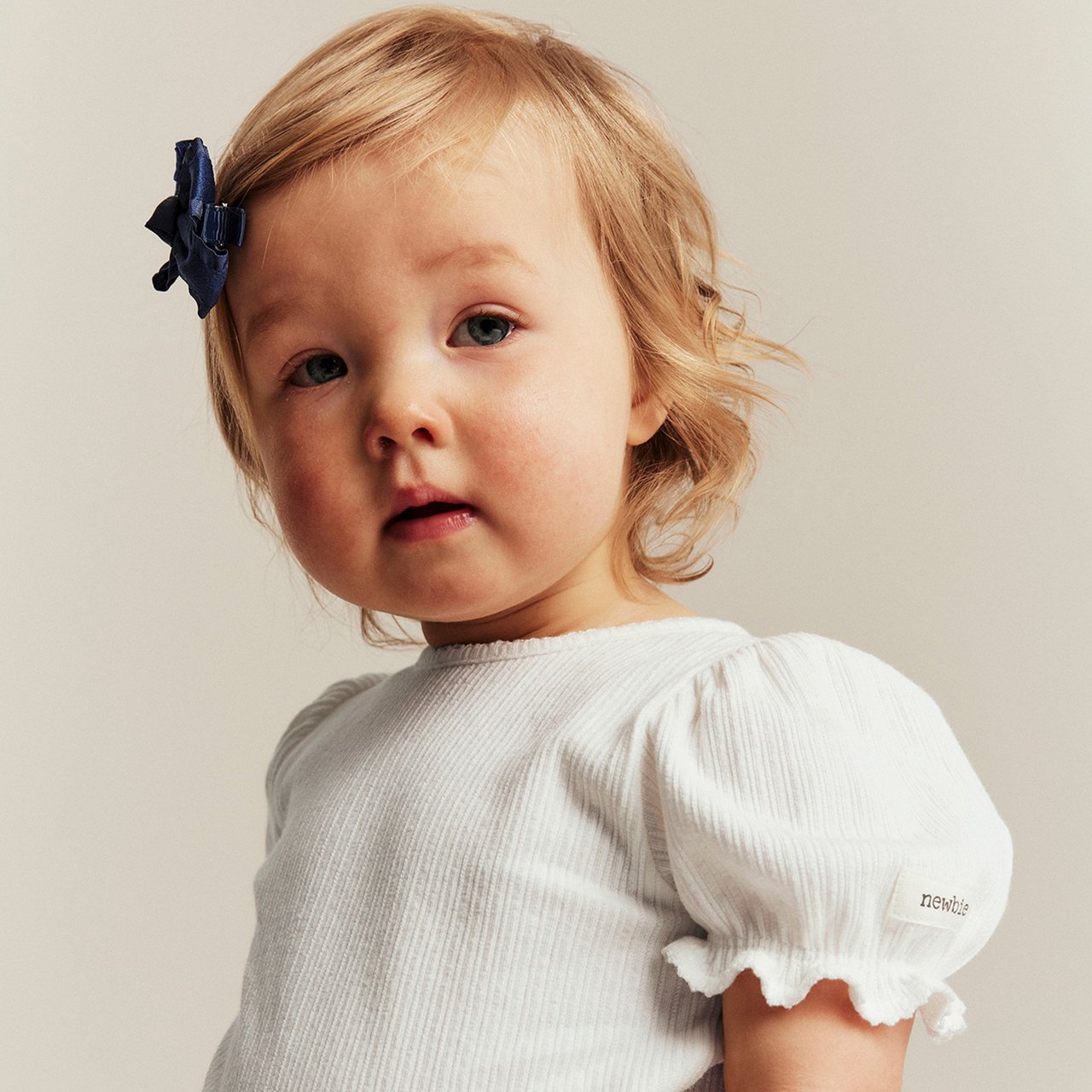 Little girl wearing a lilac cardigan