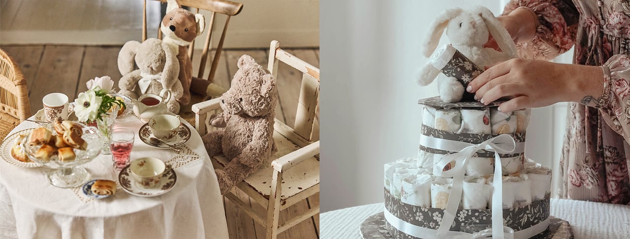 Baby shower display with teddy bears, toy rabbit and tea set beside a nappy cake topped with a plush bunny.