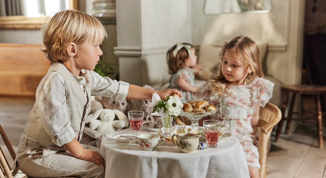 Kids having a tea party wearing cute occasionwear