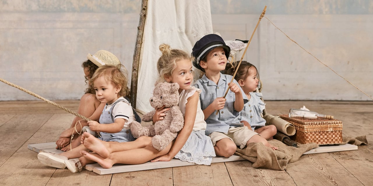 Kids sitting, dressed in sailor garments