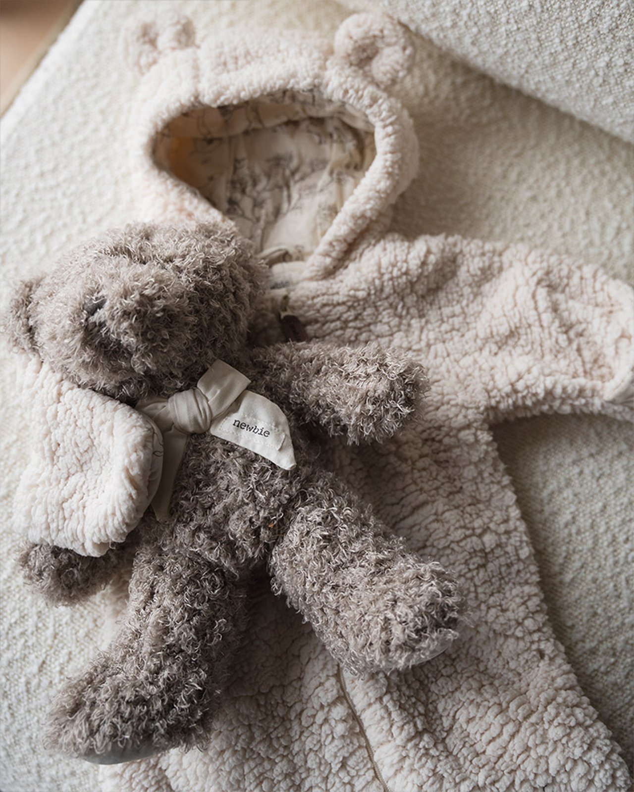 A teddy onesie and a teddy bear