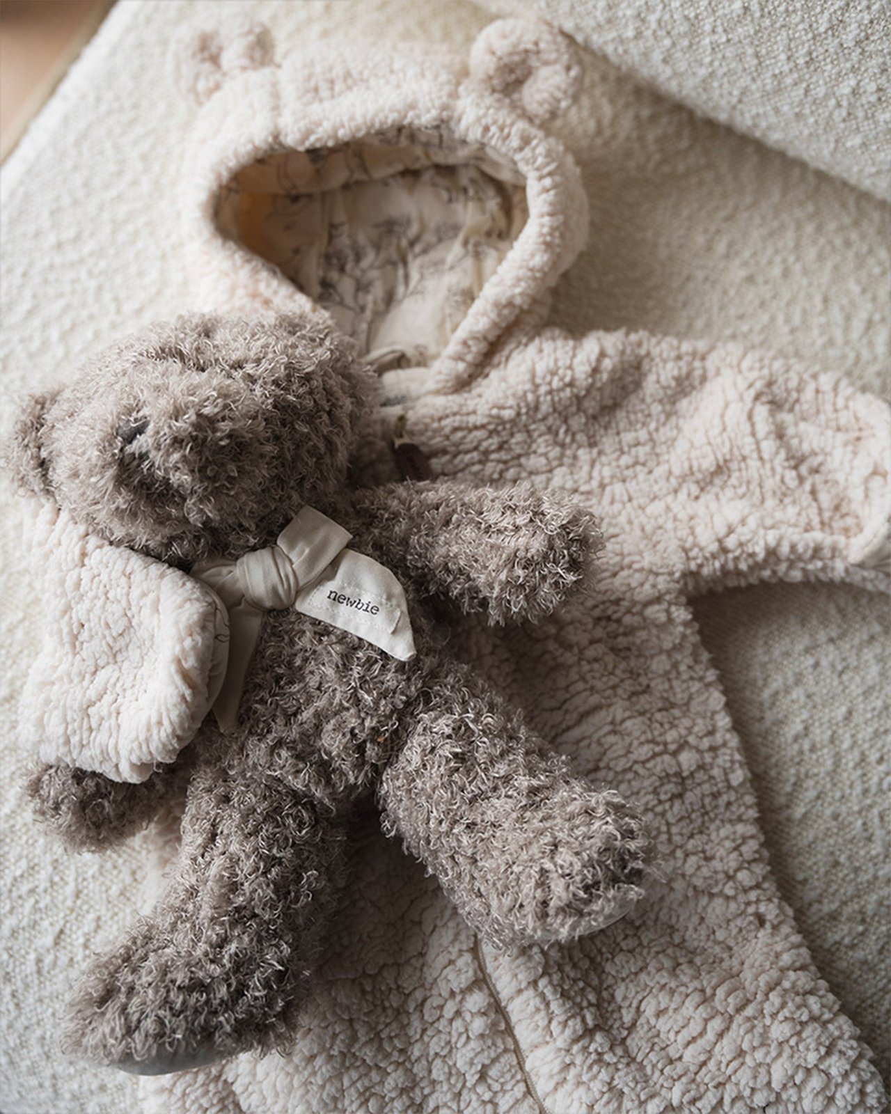 A teddy onesie and a teddy bear