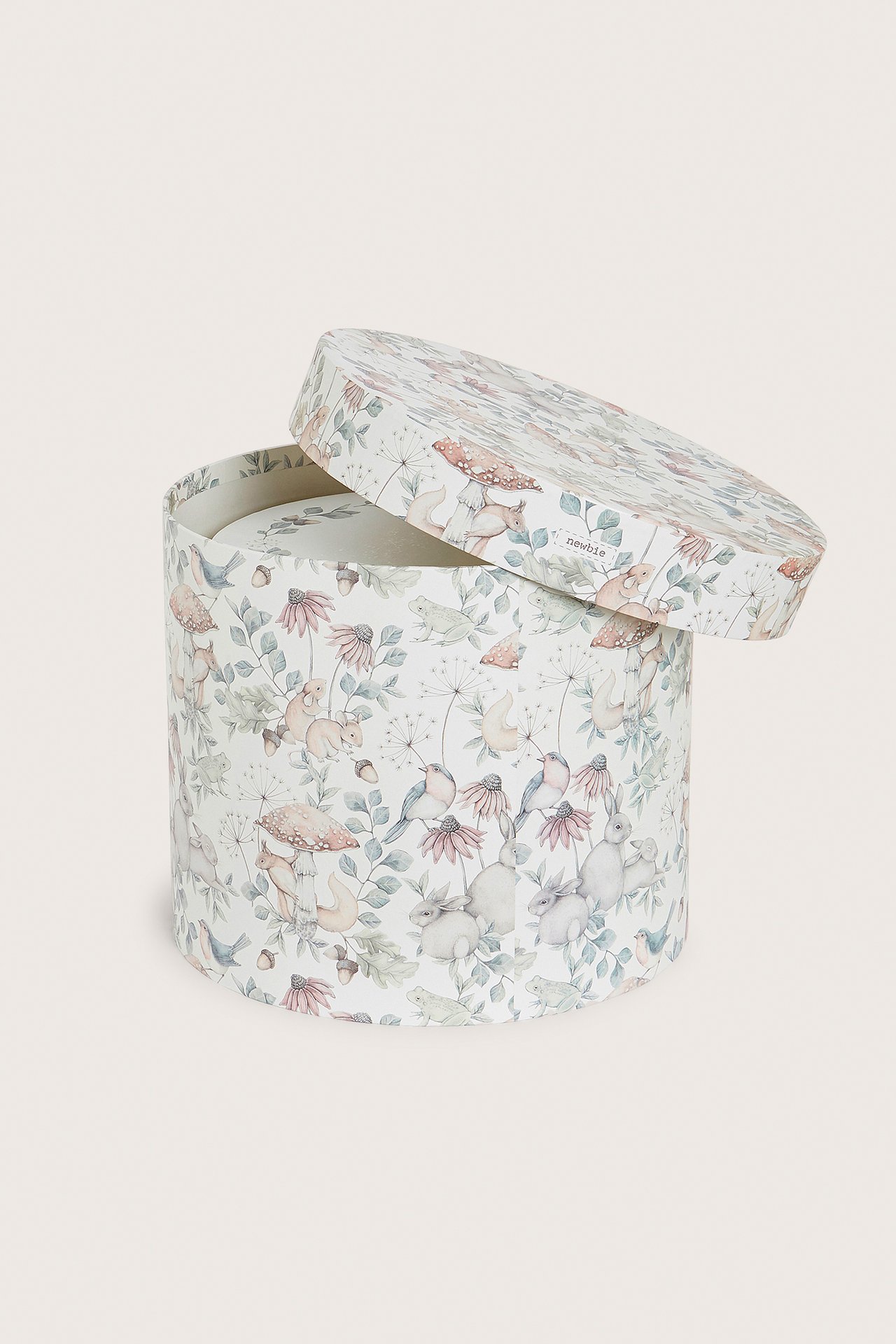 Front view of a beige round paper storage box with a nature pattern, lid slightly open.
