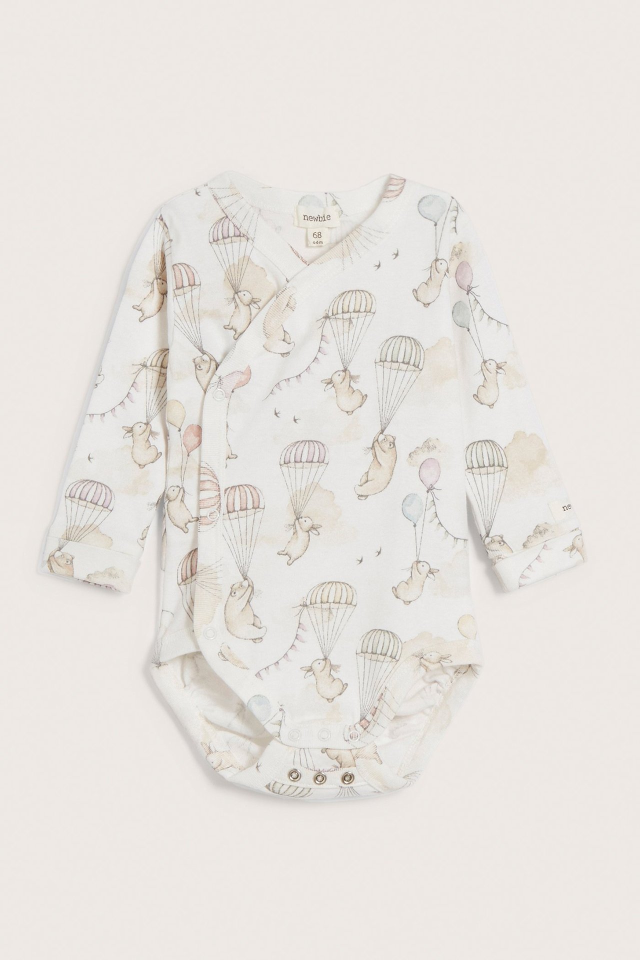 Front view: Offwhite baby wrap bodysuit with long sleeves, rabbit, bear, and balloon pattern.