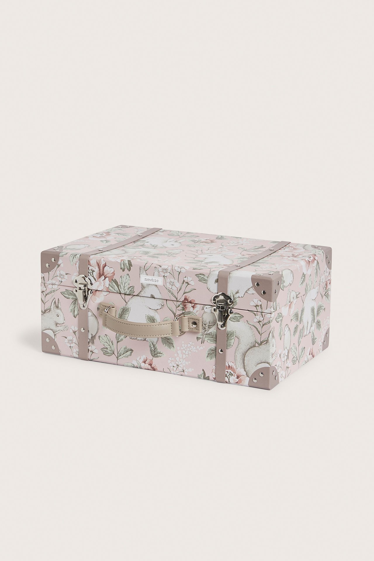 Front view of a pink hardboard storage bag with floral and animal print, beige handle, and silver clasps.