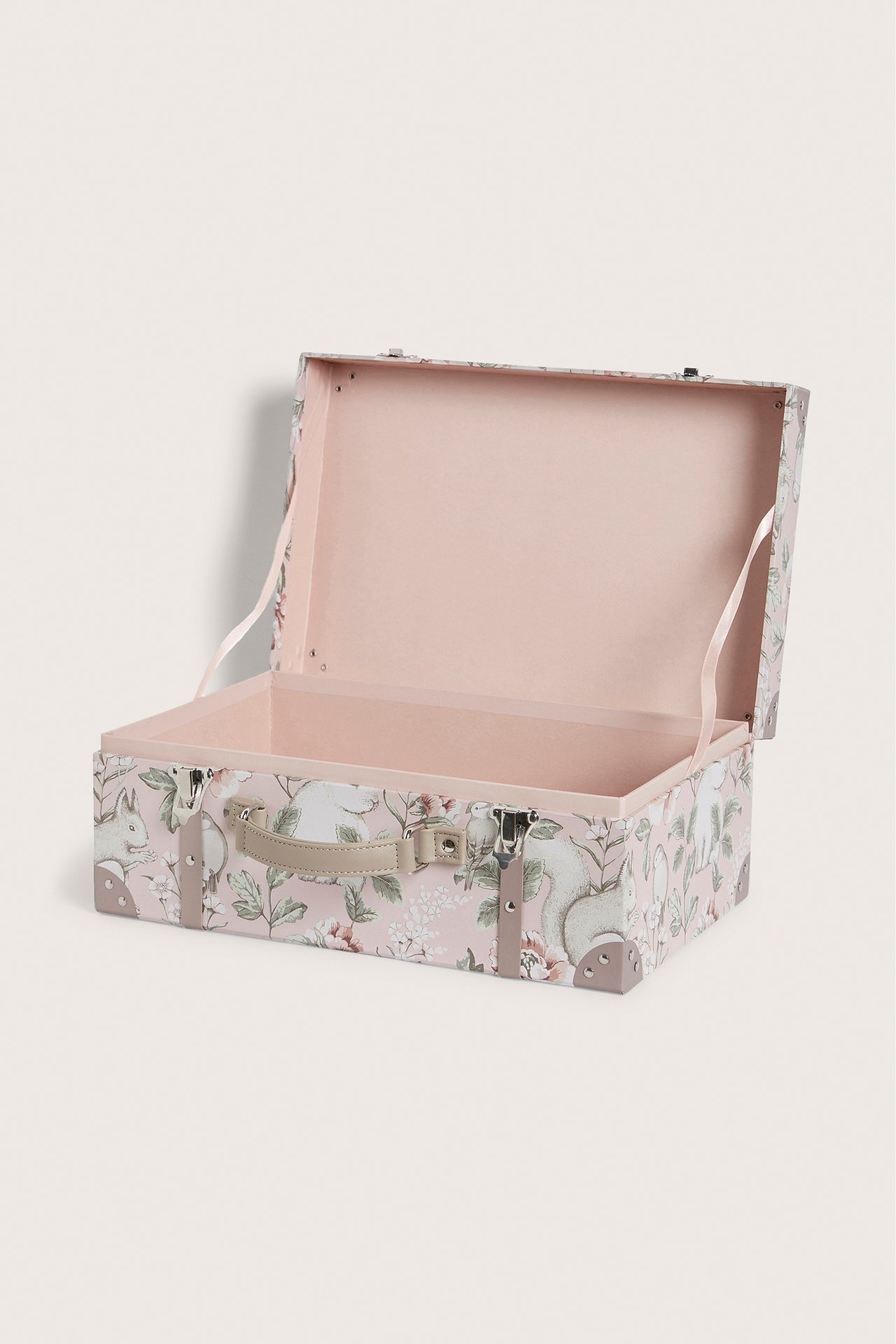 Front view of an open pink hardboard suitcase with floral and animal print, beige handle, and metal clasps.