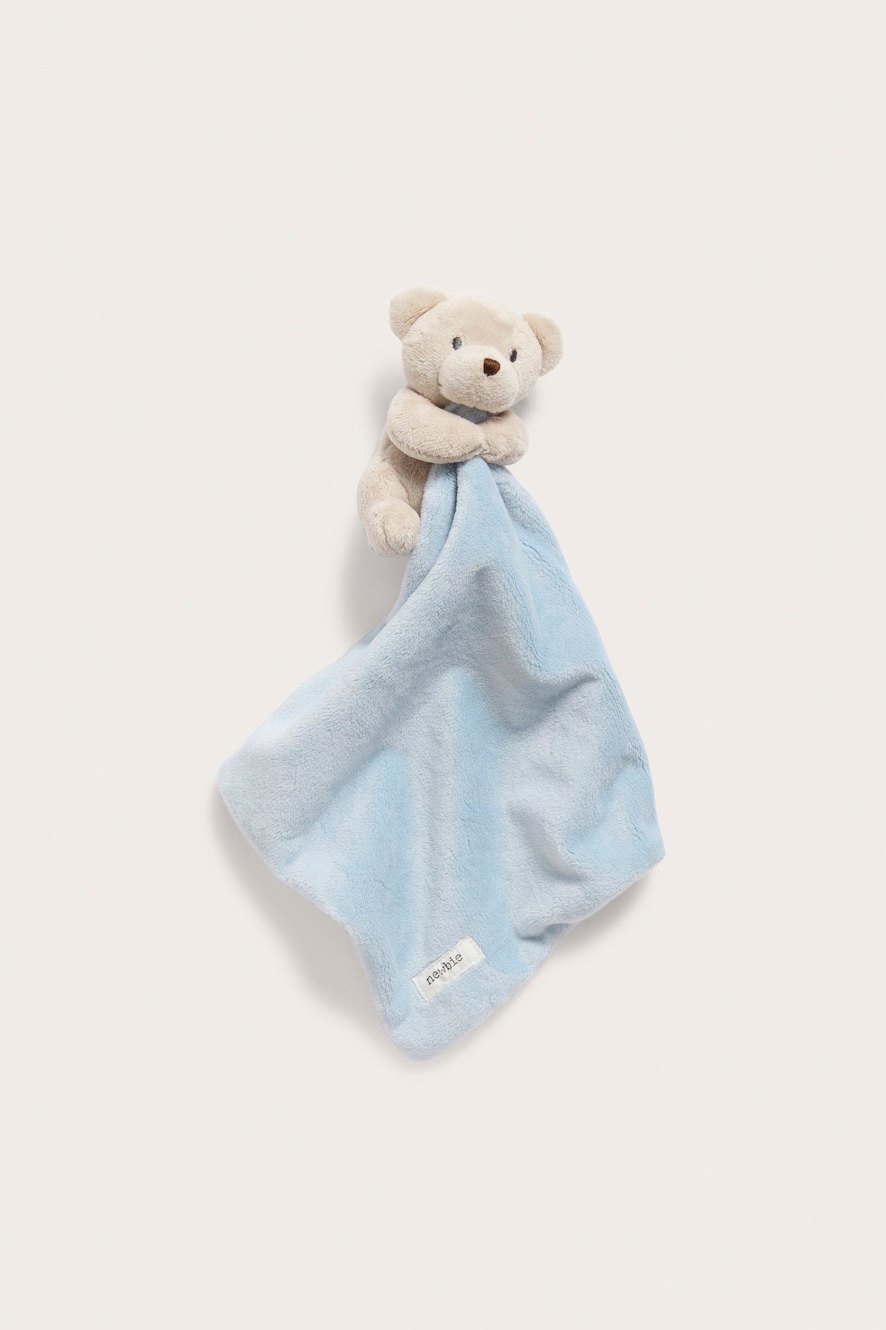 Front view of a light blue soft polyester snuggle blanket with an attached beige teddy bear head and arms.