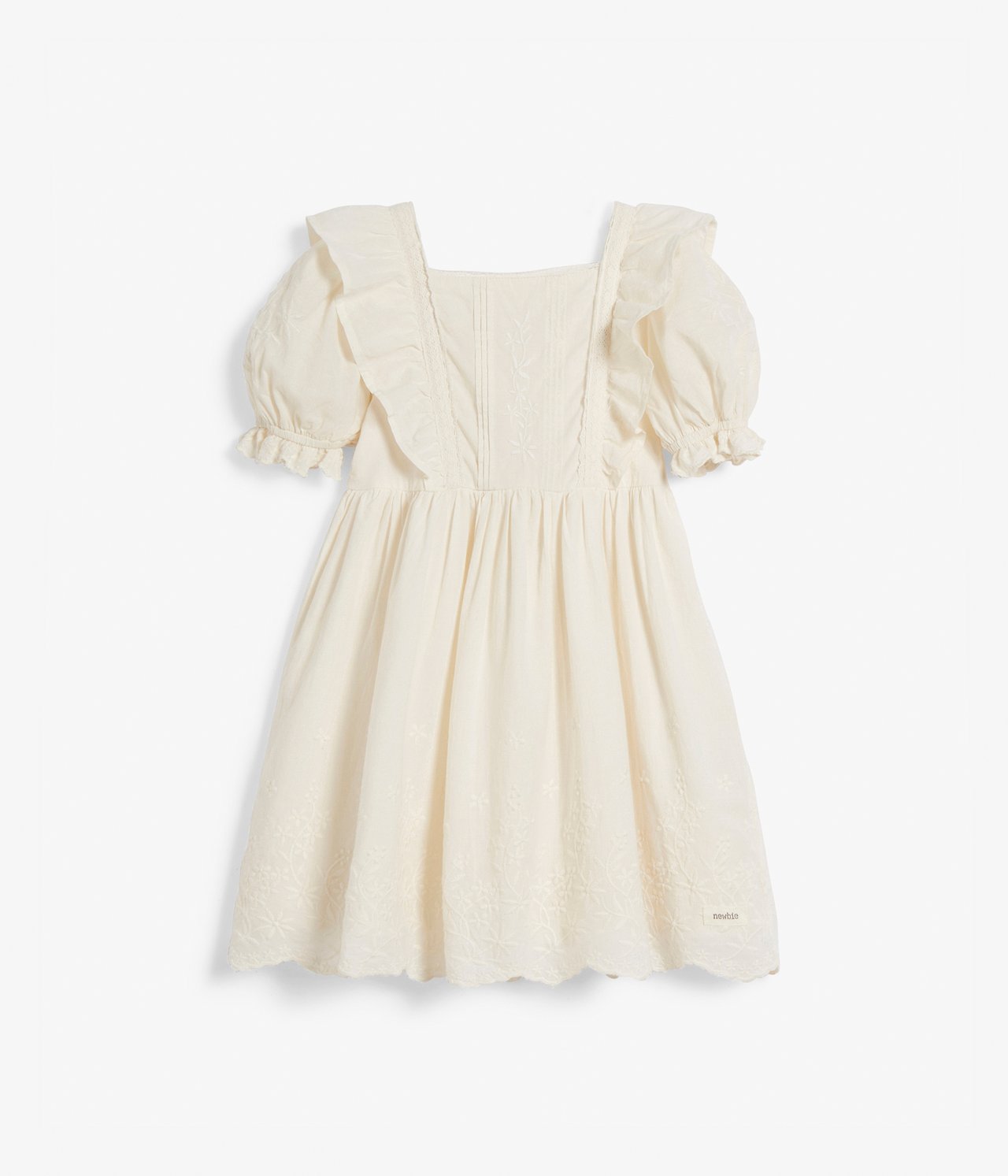 Front view of an offwhite woven cotton kid's dress with square neckline, frills, puff sleeves, and embroidery.
