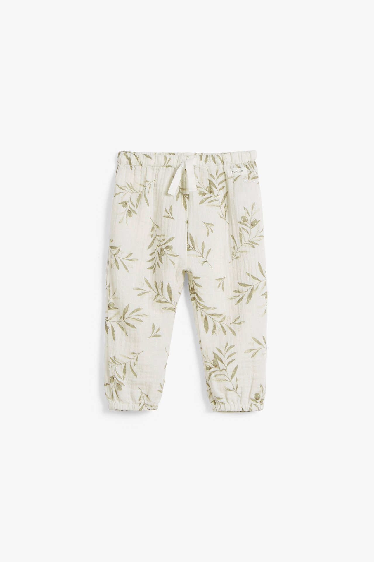 Vorderansicht von cremeweißen Babyhosen mit grünem Blattmuster, Gummibund, Kordelzug und elastischen Beinabschlüssen.