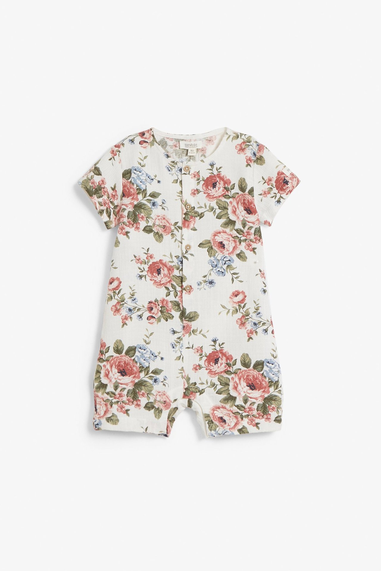 Front view: Off-white baby romper with short sleeves, pink and blue floral pattern, and front buttons.