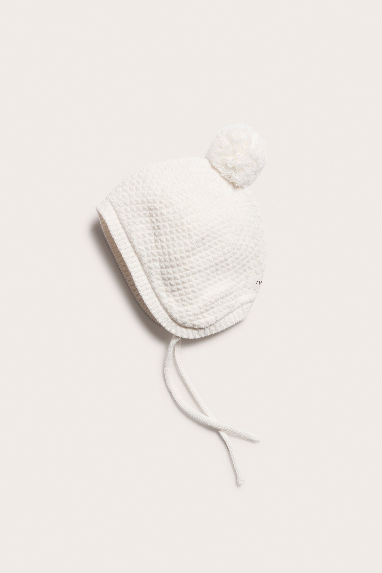 Newborn white knitted pom-pom hat