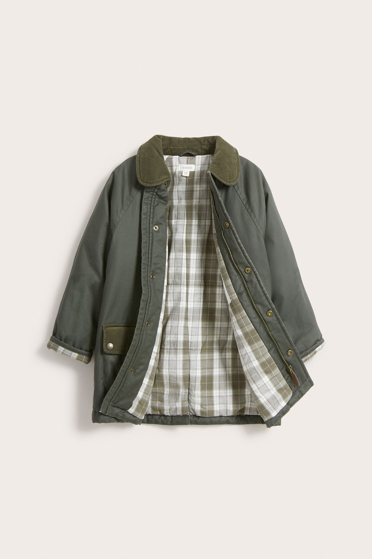 Front view of a kid's green waxed cotton jacket with a corduroy collar, open to show plaid lining.