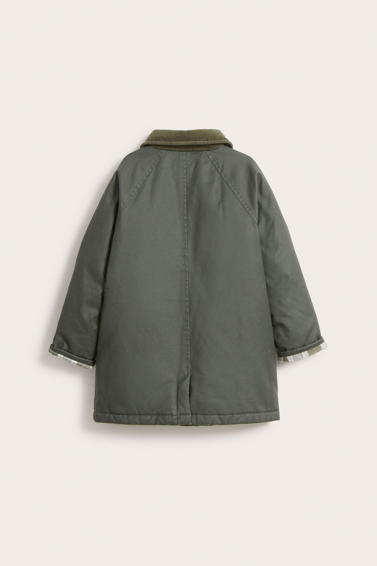 Back view of a kid's green waxed jacket with a corduroy collar and plaid lining at cuffs.