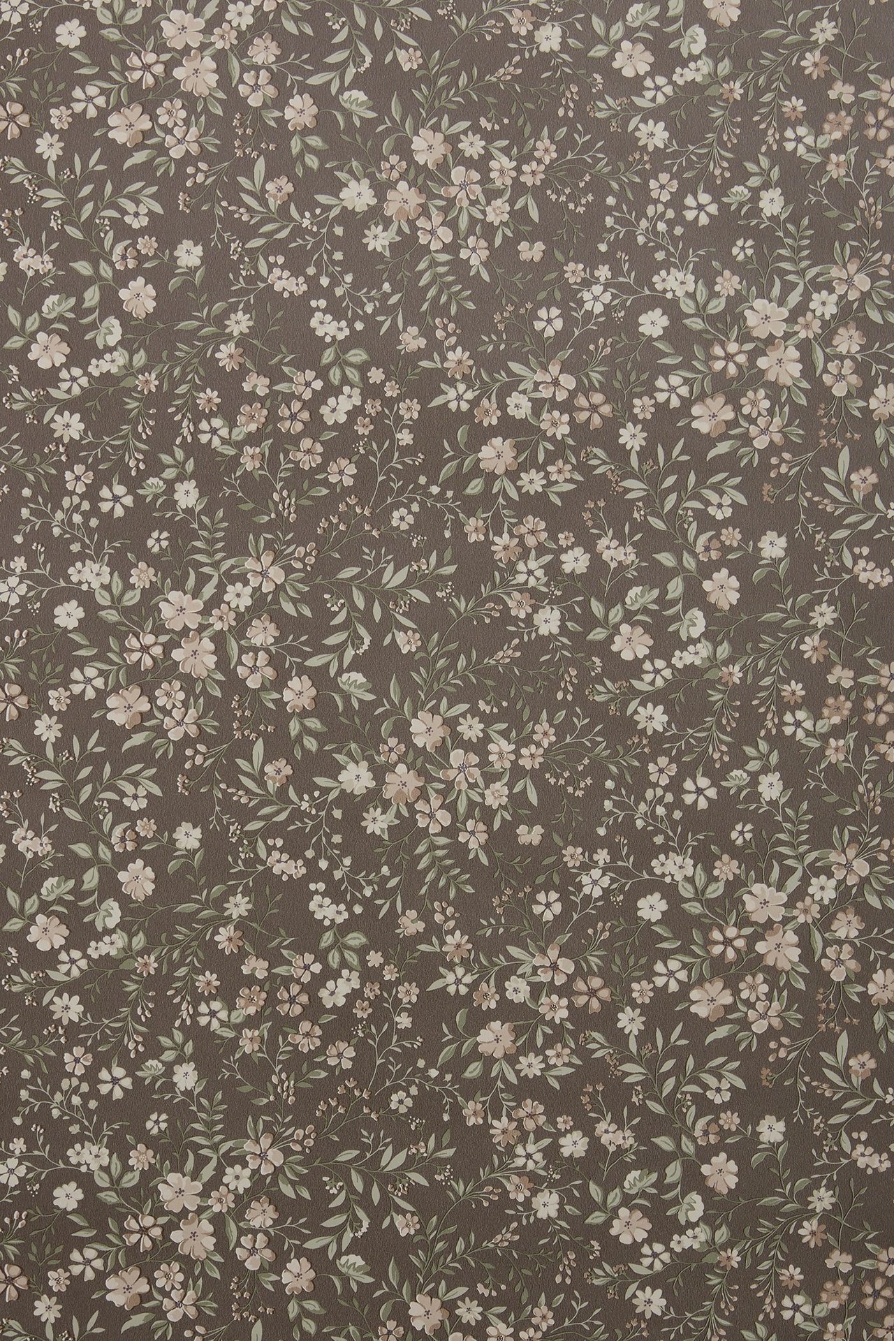Close-up of brown wallpaper with a dense pattern of small pink, cream, and green flowers and leaves.