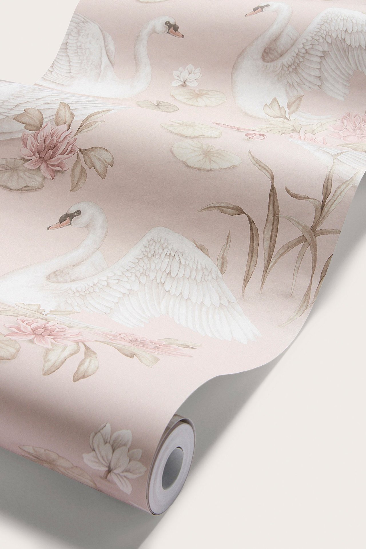 Close-up of a light pink wallpaper roll with a white swan, pink water lilies, and lily pad pattern.