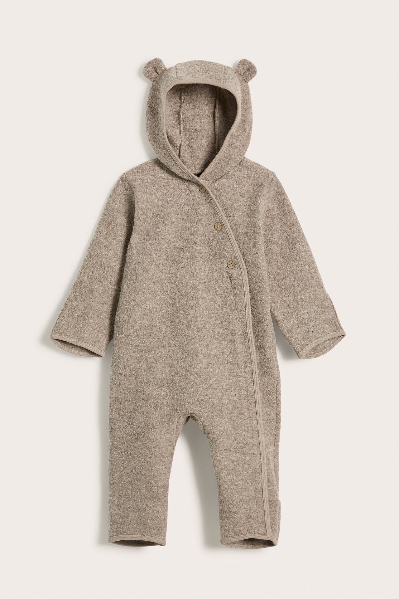 Front view of a brown melange wool baby overall with a hood, decorative ears, and button-zipper closure.
