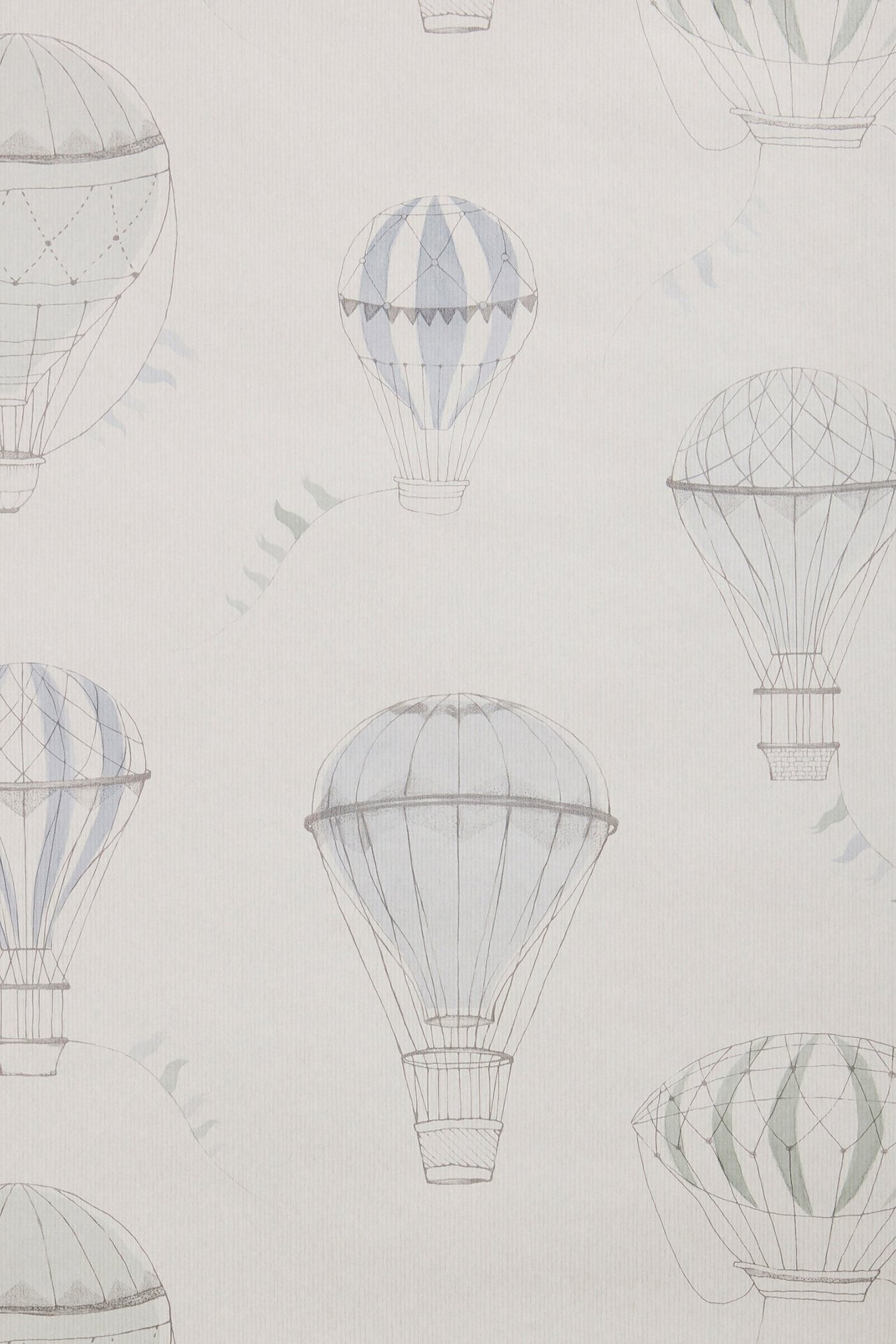 Close-up of light grey-beige wallpaper with hand-drawn blue, green, and grey hot air balloons and flag banners.