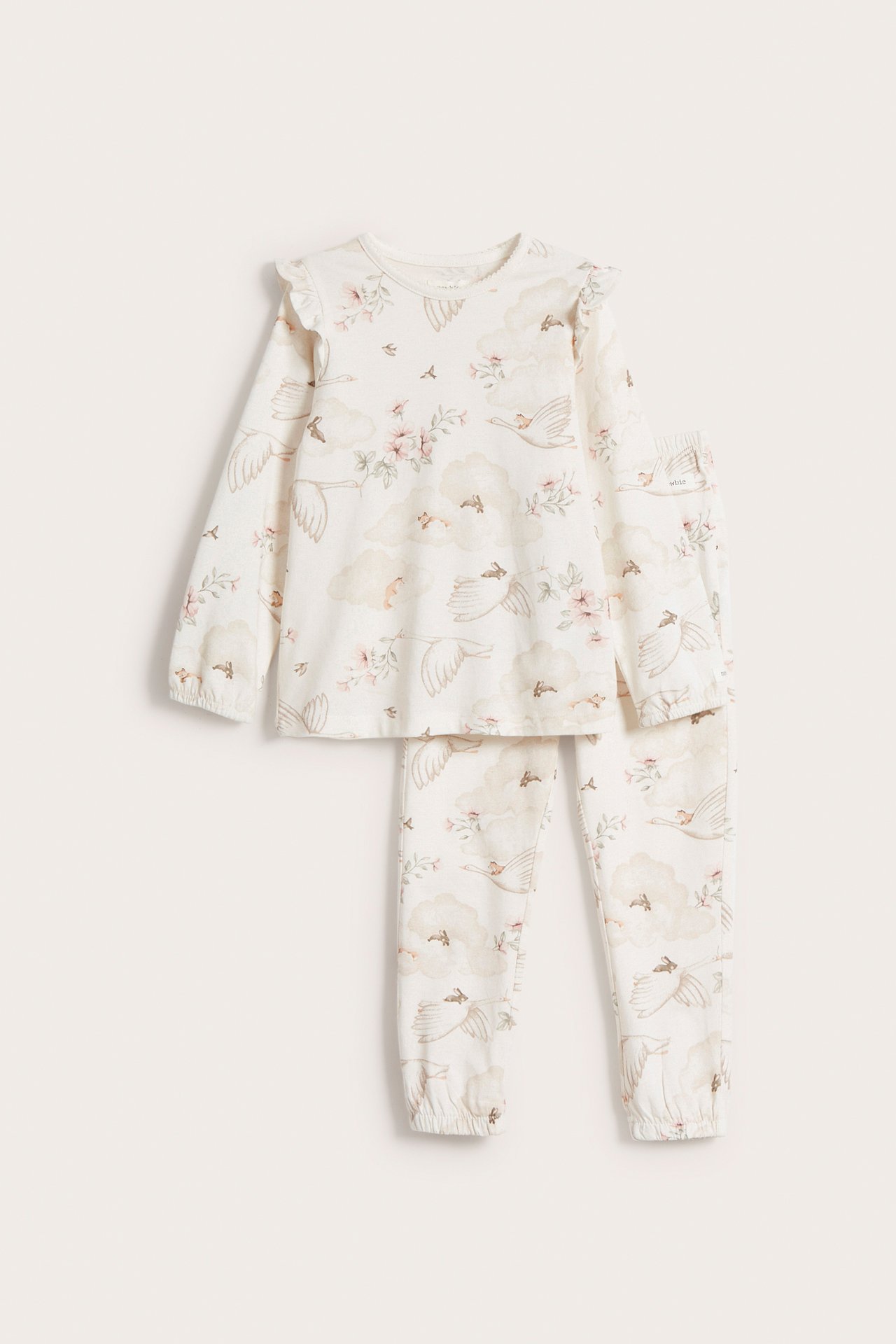 Front view of an off-white kid's cotton pyjama set with ruffles, featuring a swan, cloud, and floral print.