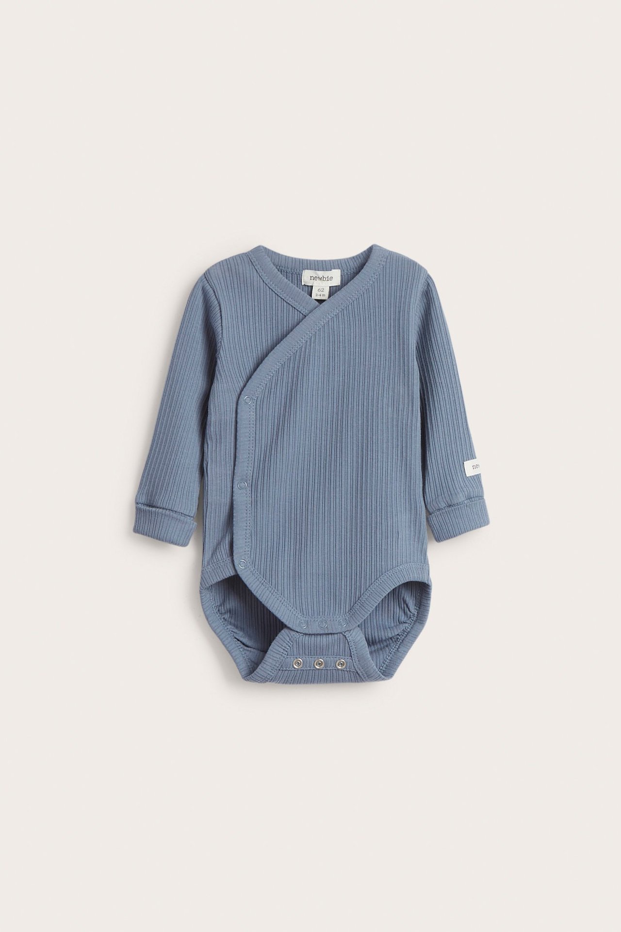 Front view of a blue ribbed baby wrap-around bodysuit with long sleeves and snap buttons.
