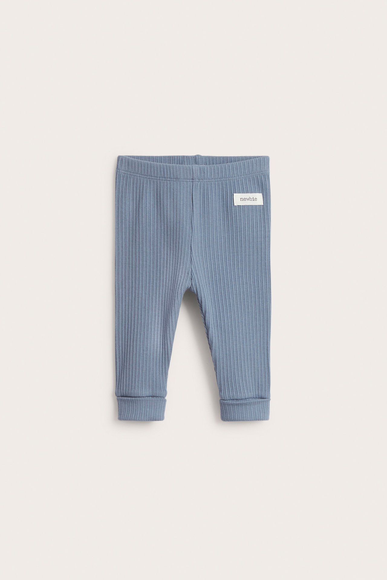 Front view of baby's blue ribbed cotton leggings with elastic waist and folded cuffs.