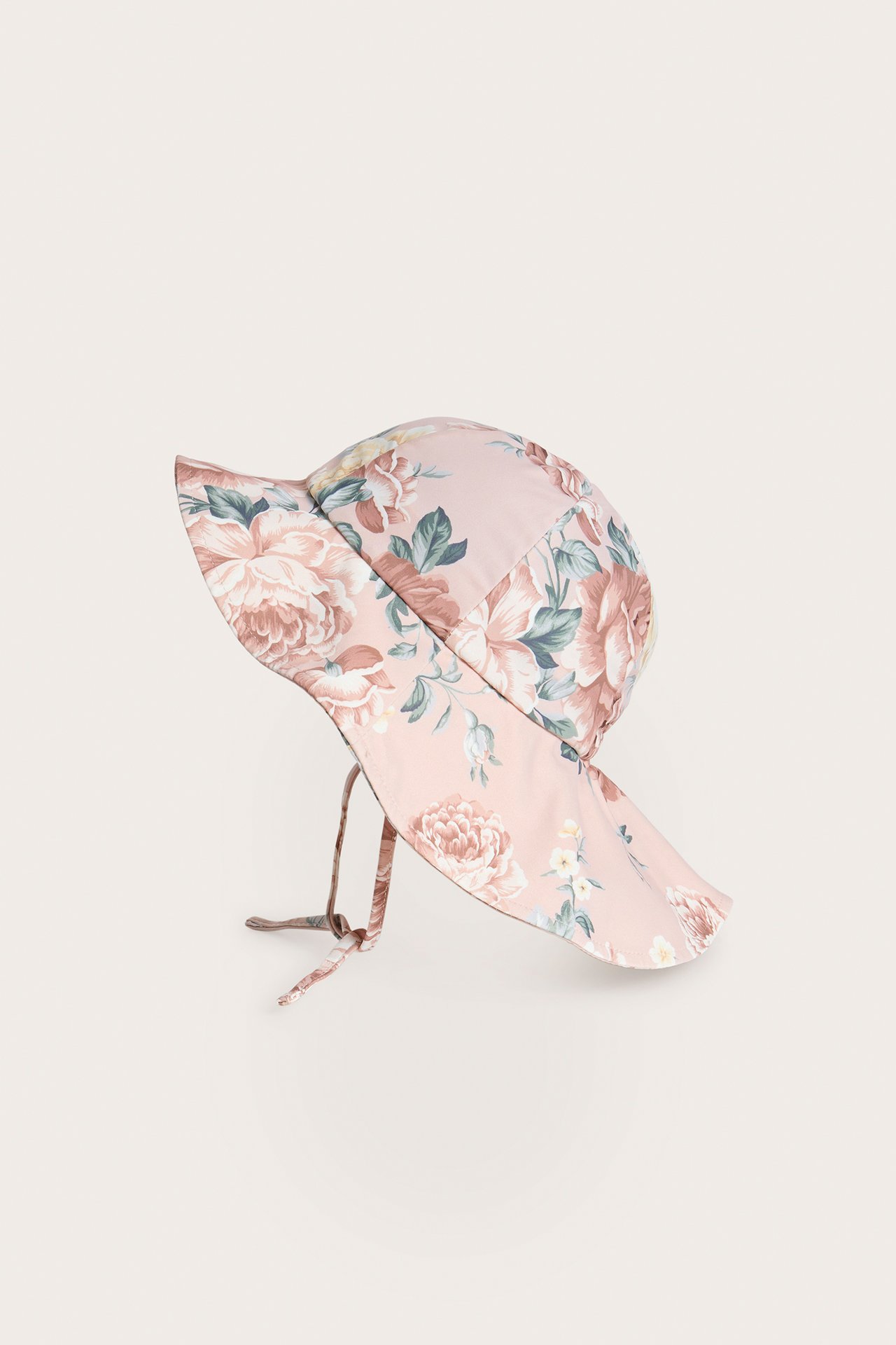 Side view of a pink floral UV sun hat for baby/kid with a wide brim and tie-bands.