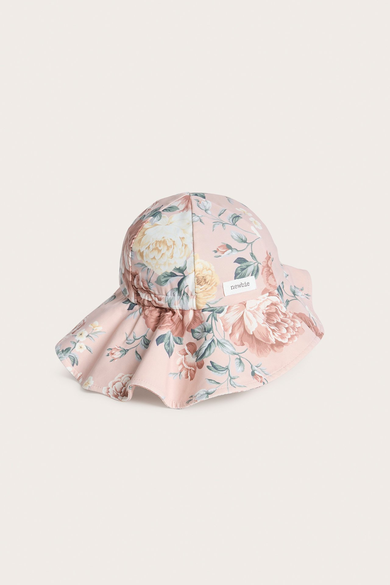 Front view of a baby's pink floral sun hat with a wide, ruffled brim.