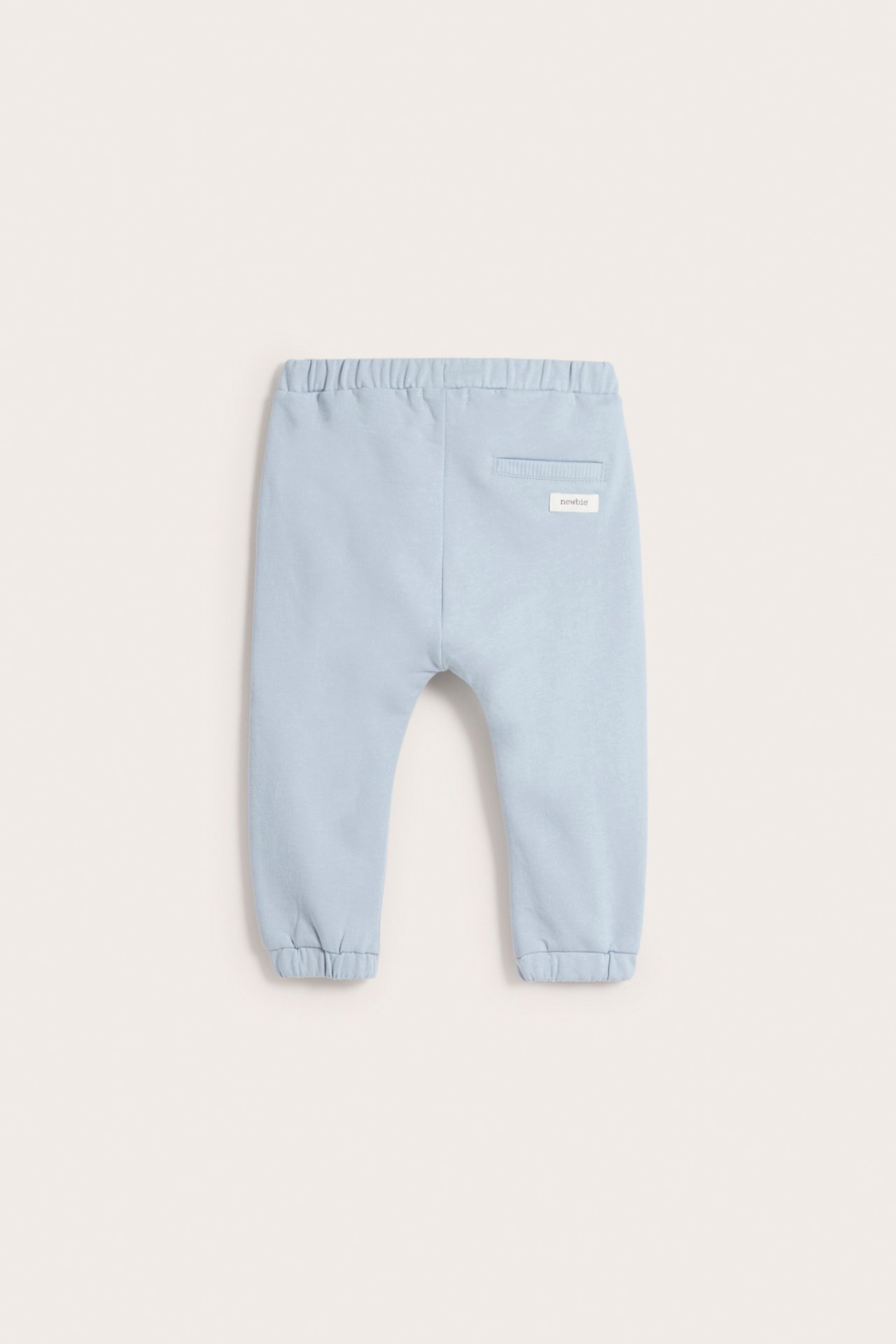 Back view of light blue baby cotton jogging pants with an elasticated waist and cuffed ankles.