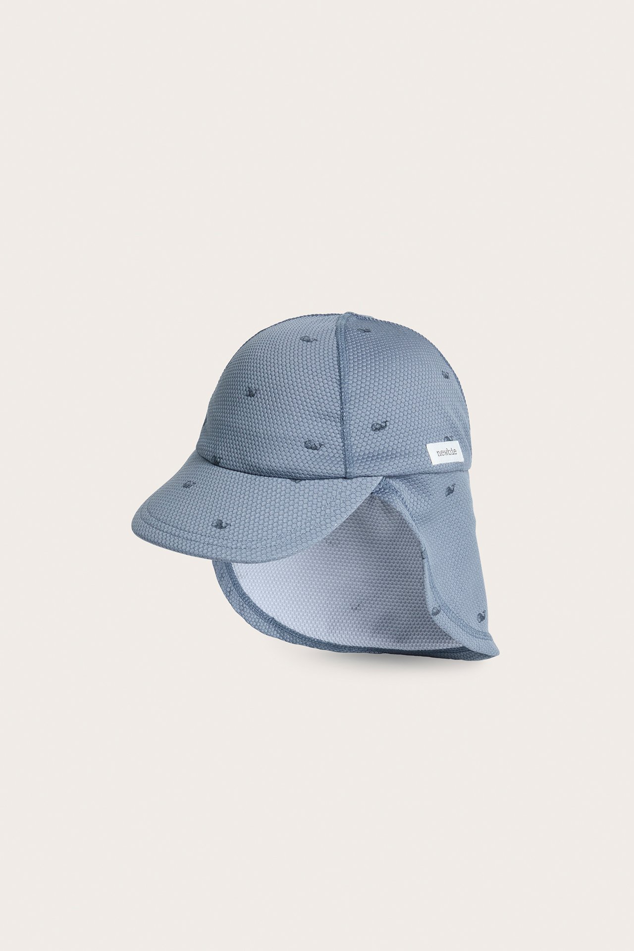 Vorderansicht einer hellblauen strukturierten Baby-UV-Kappe mit kleinem Walmuster und Nackenschutz.