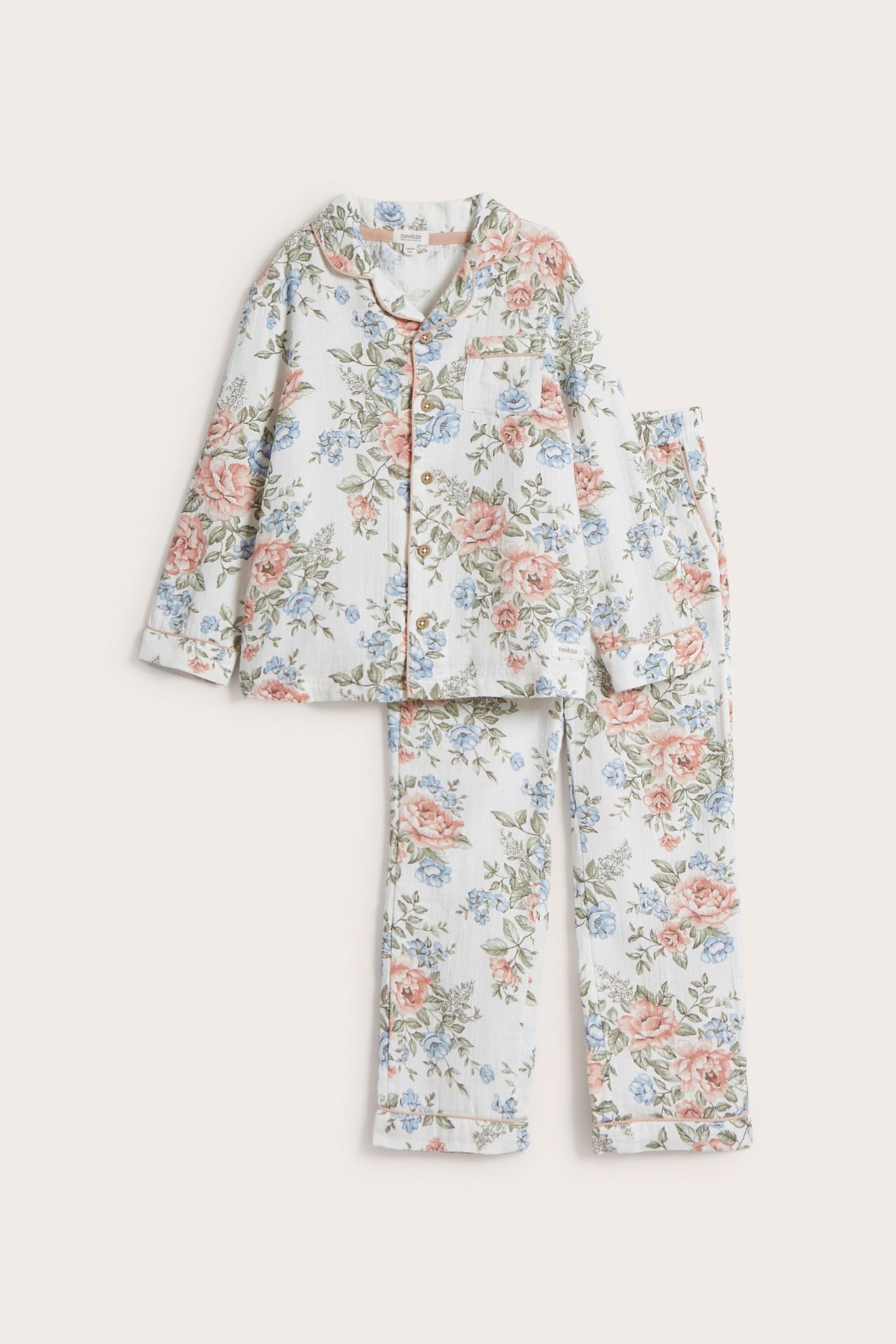 Front view of an off-white cotton floral pajama set with a button-up top and drawstring pants.