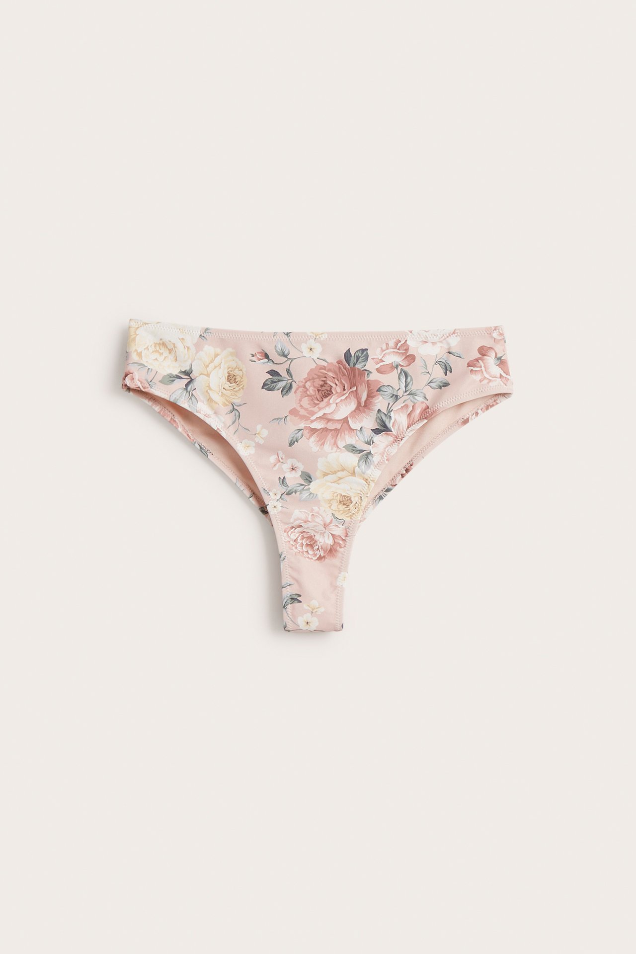 Front view of a pink floral thong bikini bottom with cream and pink roses.